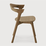This Teak Bok Dining Chair features an airy shape with rock-solid construction,  making this piece a timeless and remarkable design to enjoy for years to come. Pair with a dining table or stand-alone against a wall, hallway, or end of the bed! Designed by Alain can Havre  Dimensions: 20"w x 21.5"d x 30"h  Weight: 12 lbs  Seat Height: 18"  Material: Oak, 100% solid wood Finish: Varnished