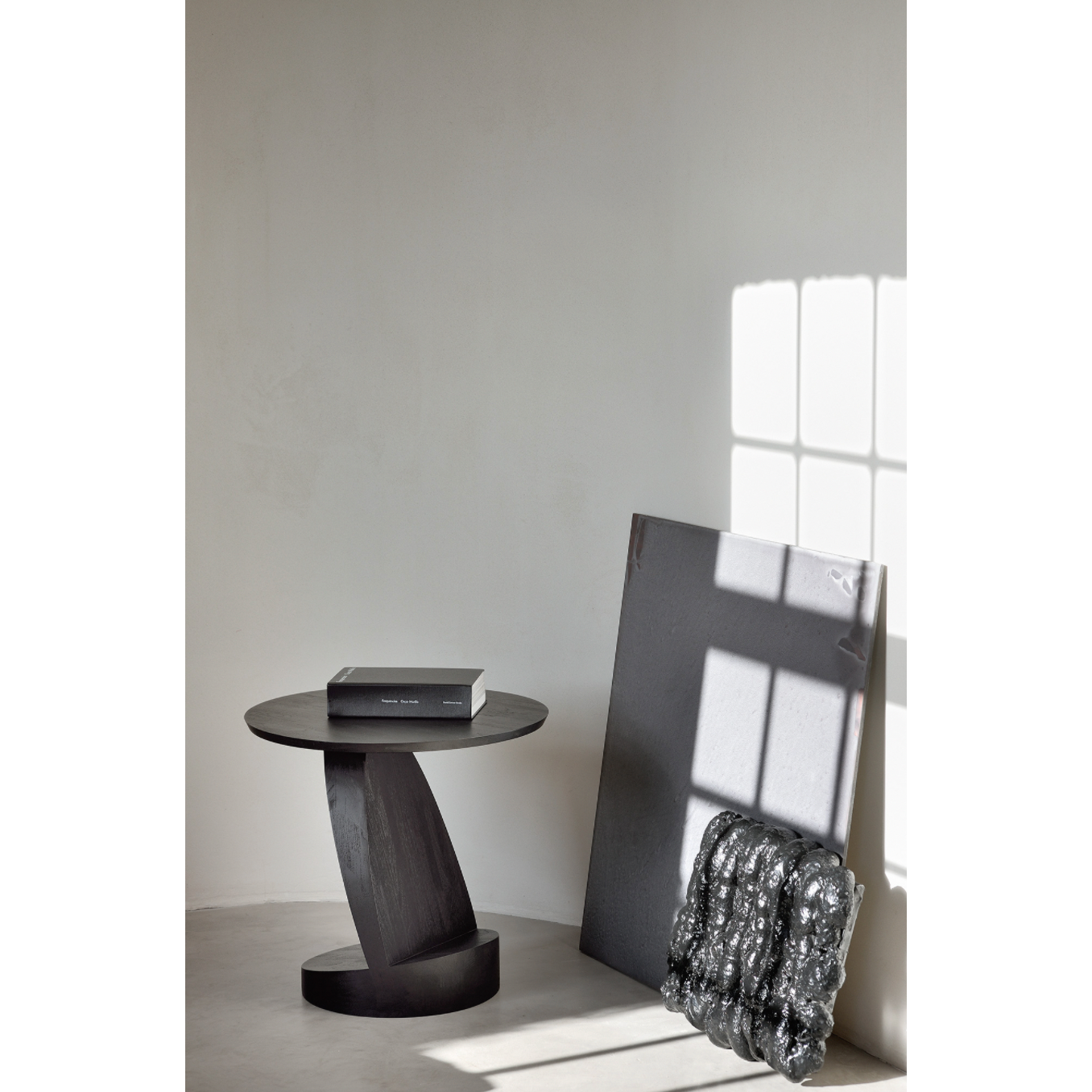 We love the unique base of this Teak Oblic Side Table - Black. Place near your sofa, bed side table, or accent chair to completely elevate the space!  Dimensions: 20.5"w x 20.5"d x 19.5"h  Weight: 21 lbs  Material: Teak, 100% Solid Wood Finish: Varnished