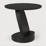 We love the unique base of this Teak Oblic Side Table - Black. Place near your sofa, bed side table, or accent chair to completely elevate the space!  Dimensions: 20.5"w x 20.5"d x 19.5"h  Weight: 21 lbs  Material: Teak, 100% Solid Wood Finish: Varnished