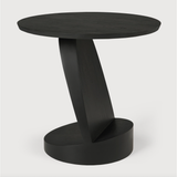 We love the unique base of this Teak Oblic Side Table - Black. Place near your sofa, bed side table, or accent chair to completely elevate the space!  Dimensions: 20.5"w x 20.5"d x 19.5"h  Weight: 21 lbs  Material: Teak, 100% Solid Wood Finish: Varnished