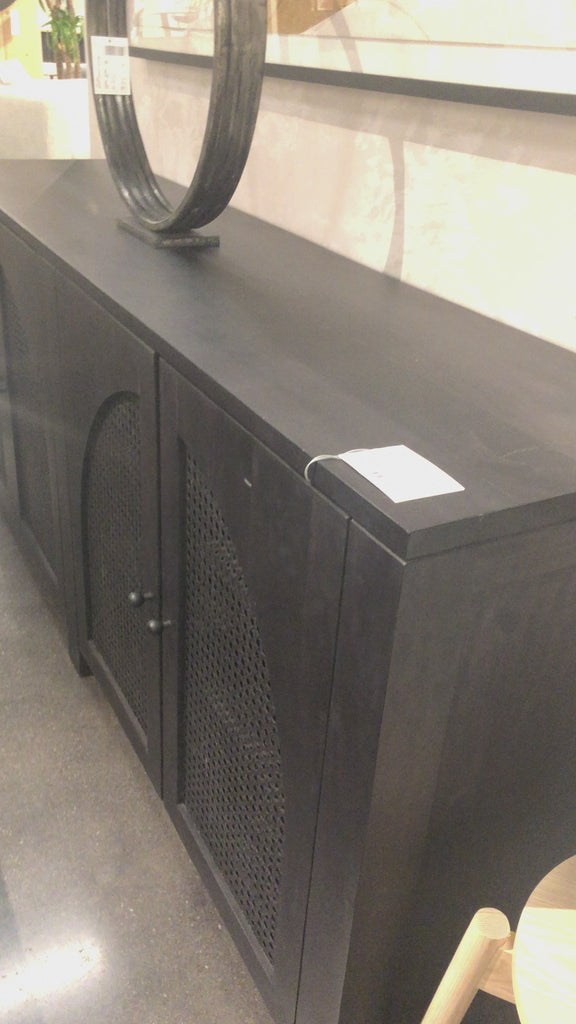 We love the textural cane door panels of the Tilda Black Wash Mango Sideboard. Store all your media needs while also adding a beautiful, monochromatic vibe to the room  Size: 78"w x 18"d x 33"h Materials: Solid Mango, Iron, Cane