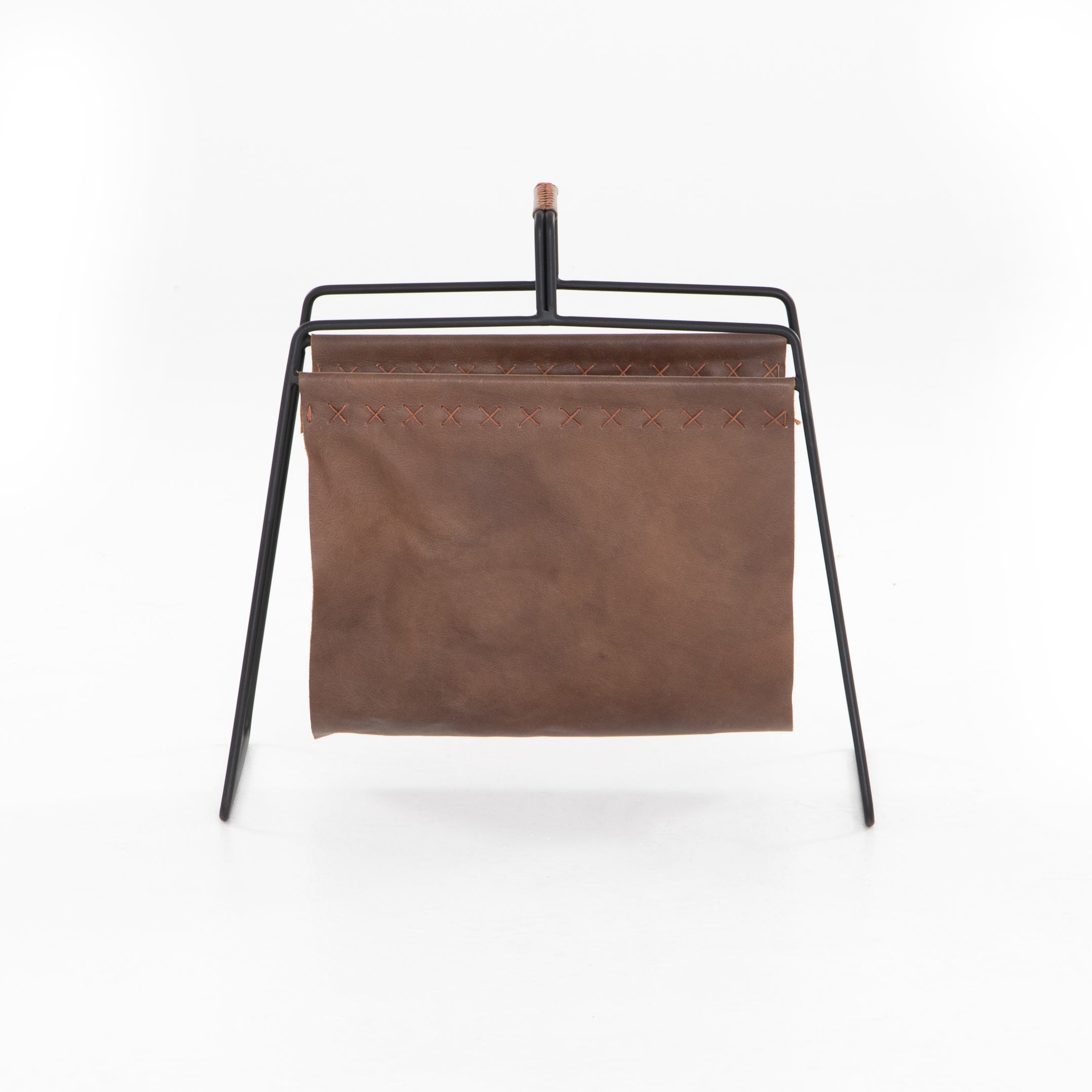 We love the cross-stitching details on this patina brown, top grain leather Aesop Magazing Rack. A gorgeous piece to place all your favorite magazines or important papers in, while also bringing a stylish mid-century vibe to your office or other space.  Overall Dimensions: 18.50"w x 11.75"d x 19.00"h Materials: Top Grain Leather, Iron Colors: Patina Brown, Smooth Jet Black