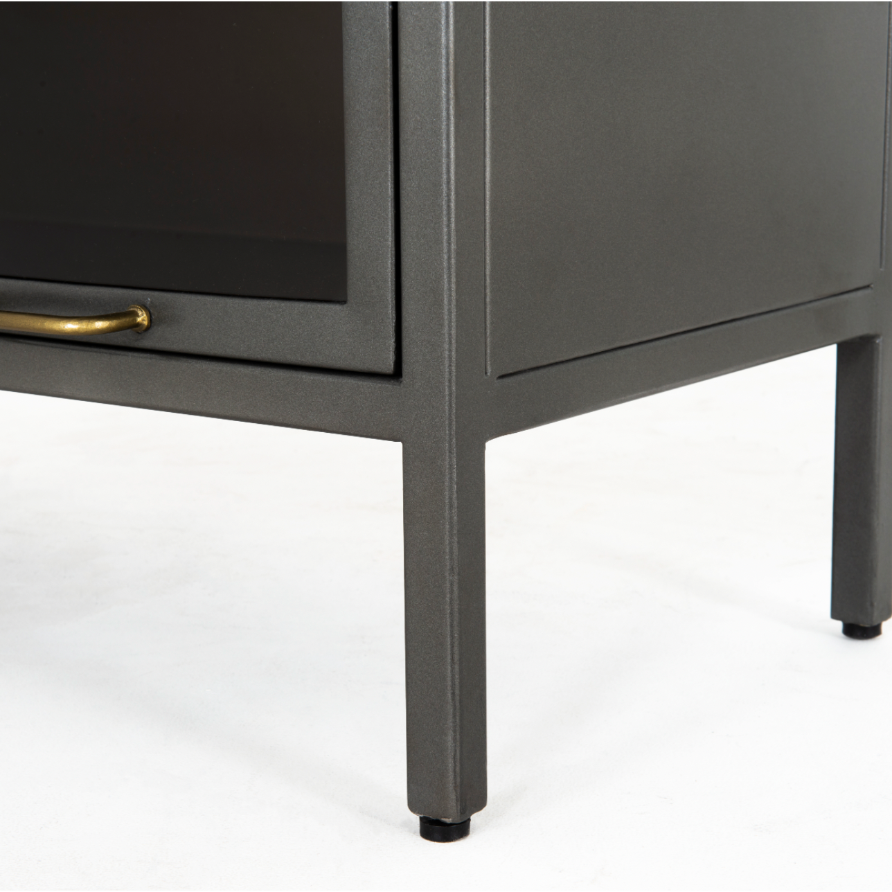 Inspired by the stackable barrister-style shelving, iron casing is finished in a gunmetal for a fresh industrial look, with smoked glass panes with flat brass hardware cover door fronts, each lifting to spacious compartments for storage of books and treasures.  Overall Dimensions: 32.00"w x 15.00"d x 82.00"h  Colors: Smoked Glass, Flat Brass, Gunmetal Materials: Glass, Iron