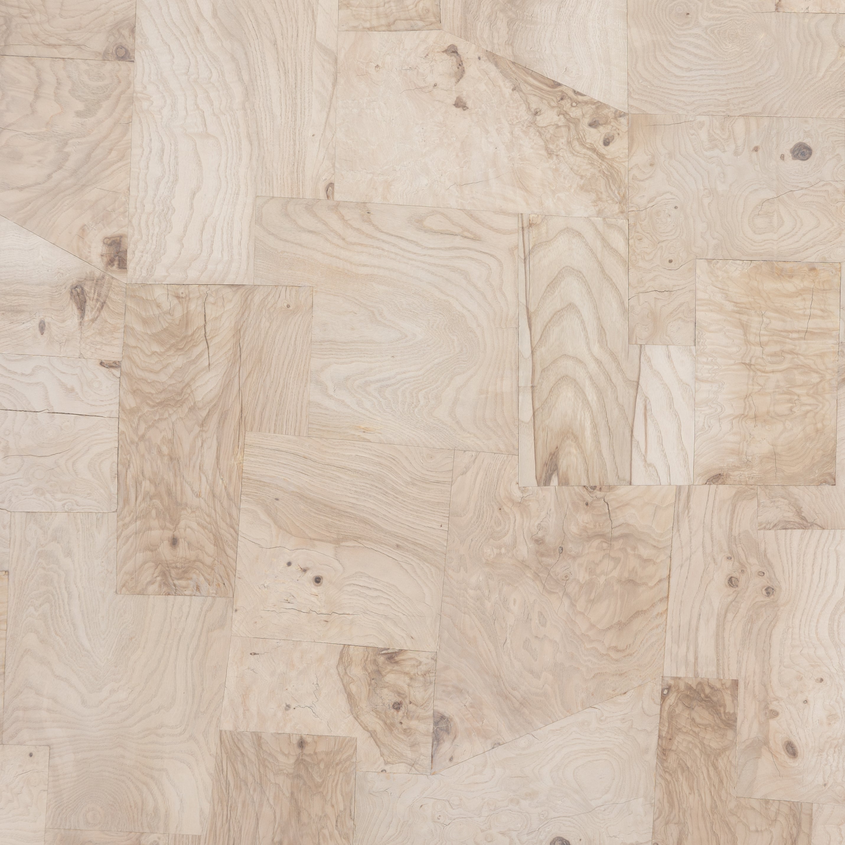 Made from bleached ash burl, this Blanco Coffee Table - Bleached Burl is a soft-squared tabletop featuring a patchwork pattern to bring novel movement to the modern coffee table. Finished in an ashen walnut, mahogany veneer sides and an inset base complete a beautifully light look for any living room or lounge area.   Overall Dimensions: 40.00"w x 40.00"d x 16.00"h