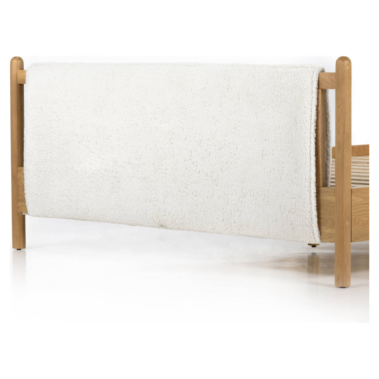 Bring a cozy hygge vibe to the bedroom with this textured Bowen Bed. Framed by light-finished solid oak, a sling-style bed features faux shearling head and foot boards -- sure to elevate any bedroom.   Queen Overall Dimensions: 64.25"w x 87.25"d x 48.00"h King Overall Dimensions: 80.25"w x 88.50"d x 48.00"h