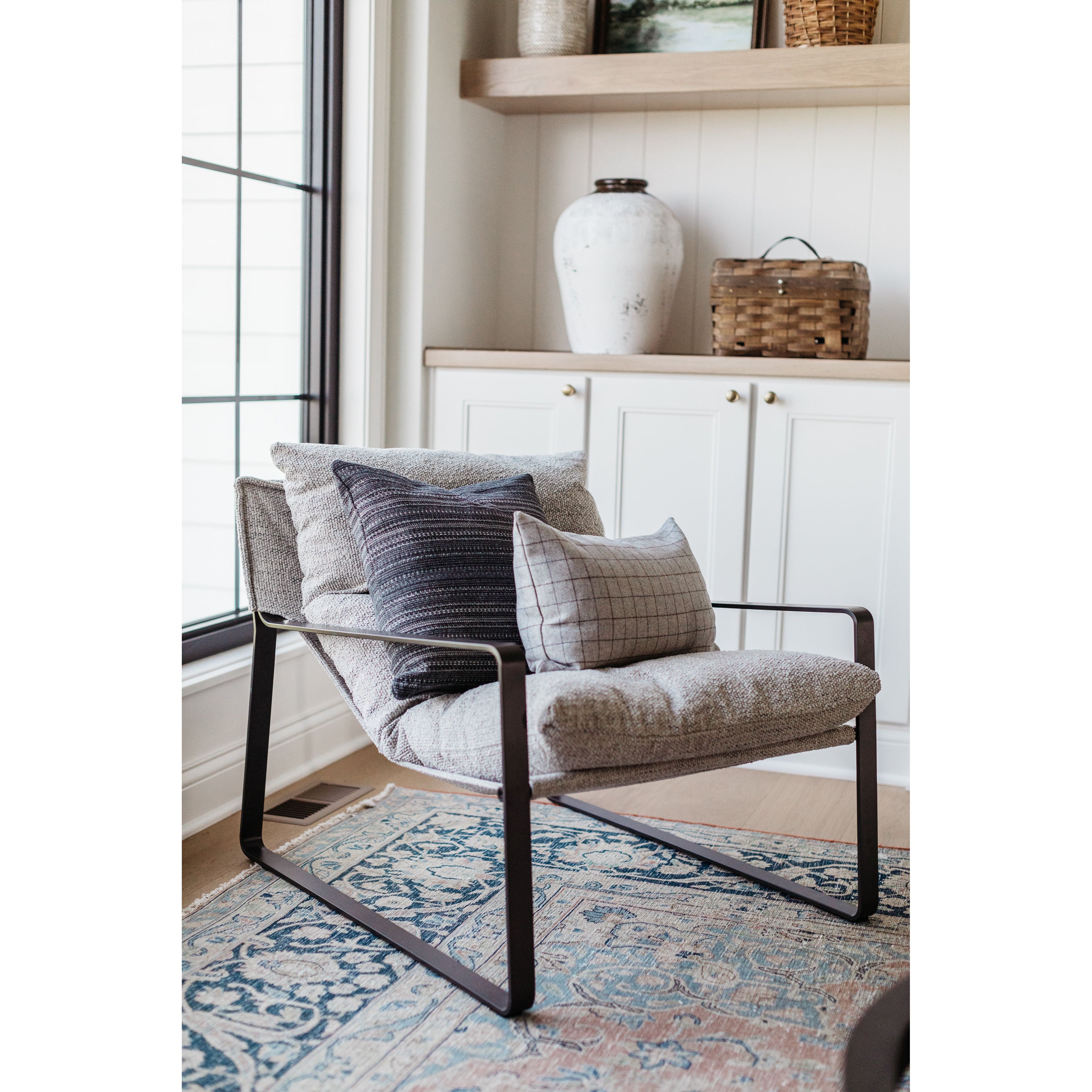 Super stylish, effortlessly cool, this Emmett Sling Chair - Merino Porcelain is upholstered with beautifully chunky seagrass texture and a sling-style seating that sits low and curved for a fresh take on a throwback form. Industrial gunmetal-finished iron framing turns up the drama one more notch for any living room, office, or other space.   Overall Dimensions: 29.00"w x 36.00"d x 29.00"h