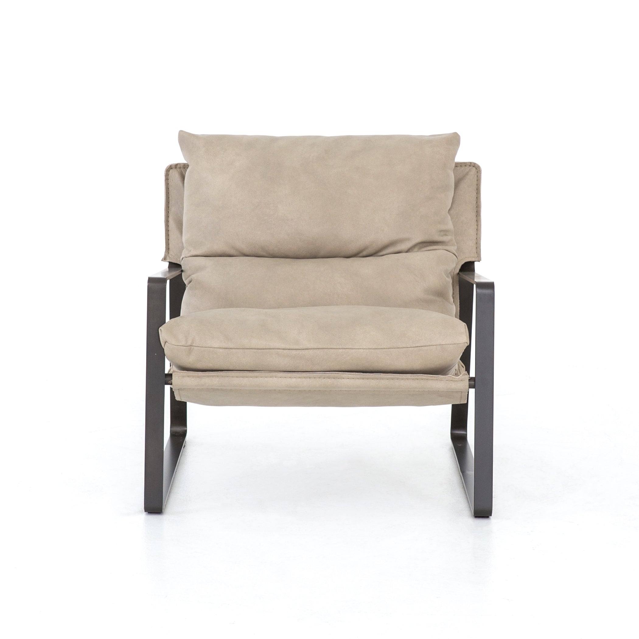 Super stylish, effortlessly cool - this Emmett Sling Chair - Umber Natural has light leather that sits low and curved for a fresh take on a throwback form. Slim, gunmetal-finished iron framing elevates the space for any living room or lounge area.   Overall Dimensions: 29.00"w x 36.00"d x 29.00"h