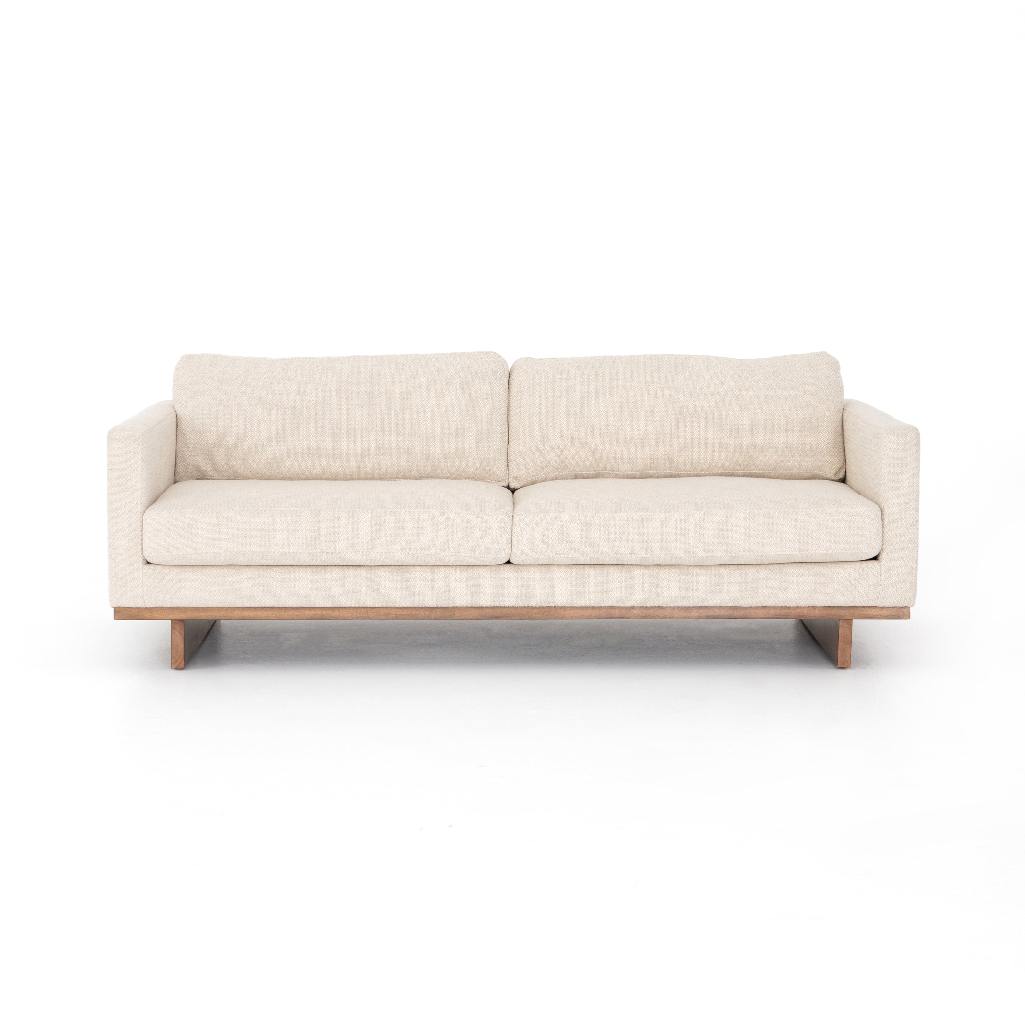Classic goes contemporary with this Everly Sofa - Irving Taupe. A cocoa-finished parawood base supports low, deep seating of performance-grade upholstery in an invitingly neutral taupe, with track arms for a clean touch for any living room or lounge area.   Overall Dimensions: 84.00"w x 43.00"d x 32.00"h