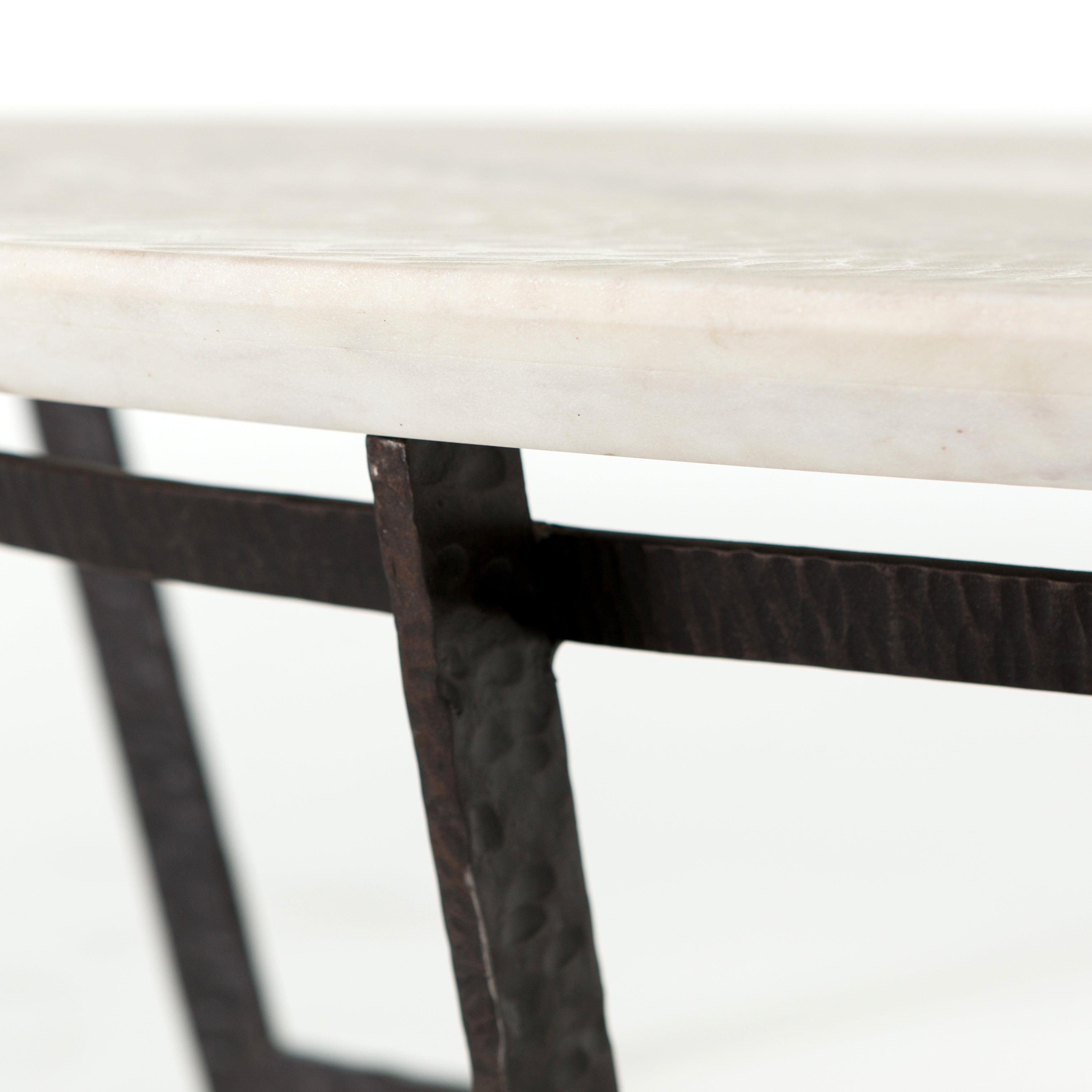 We love the textured top and geometric base of this Felix Round Coffee Table - Sandblasted White Marble. Place in your living room or lounge area to bring a sophisticated look to the space.  Overall Dimensions: 48.00"w x 48.00"d x 15.00"h Colors: Rustic Fossil, Sandblasted White Marble Materials: Iron, Marble Weight: 189.6 lb