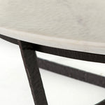 We love the textured top and geometric base of this Felix Round Coffee Table - Sandblasted White Marble. Place in your living room or lounge area to bring a sophisticated look to the space.  Overall Dimensions: 48.00"w x 48.00"d x 15.00"h Colors: Rustic Fossil, Sandblasted White Marble Materials: Iron, Marble Weight: 189.6 lb