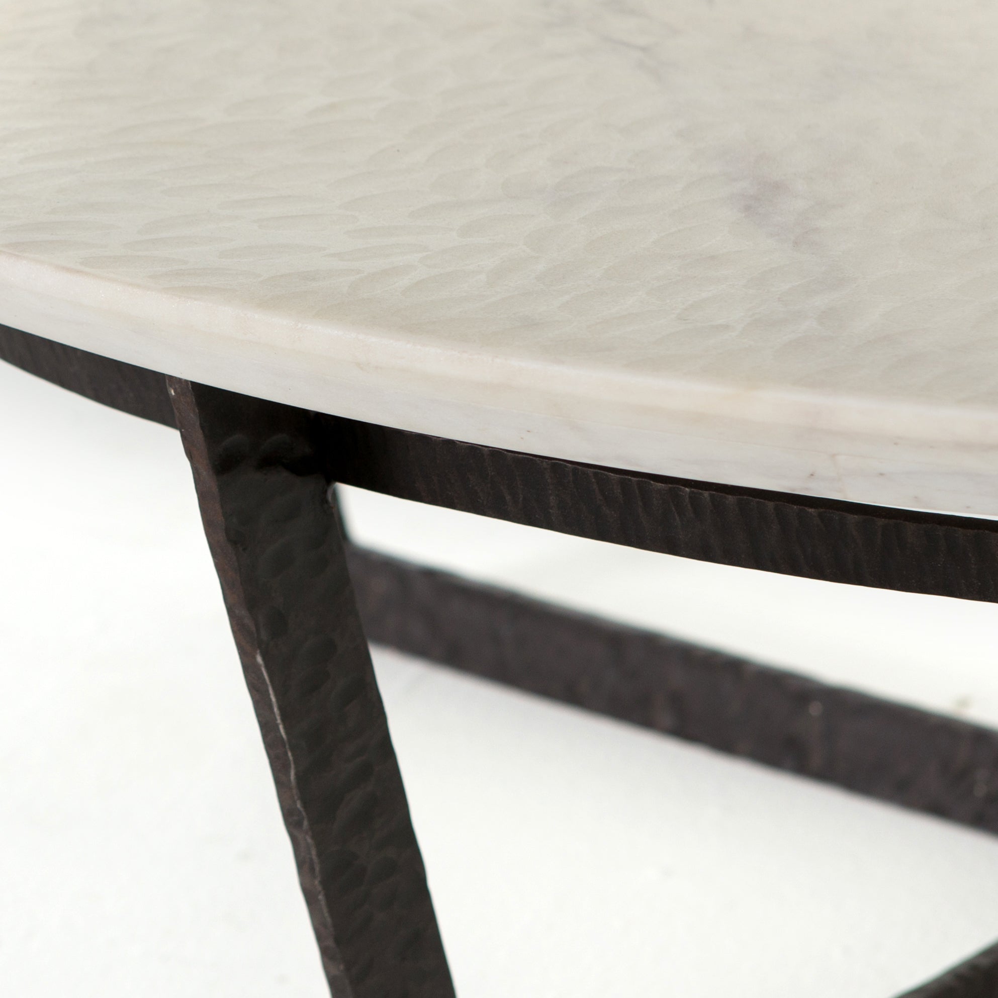 We love the textured top and geometric base of this Felix Round Coffee Table - Sandblasted White Marble. Place in your living room or lounge area to bring a sophisticated look to the space.  Overall Dimensions: 48.00"w x 48.00"d x 15.00"h Colors: Rustic Fossil, Sandblasted White Marble Materials: Iron, Marble Weight: 189.6 lb