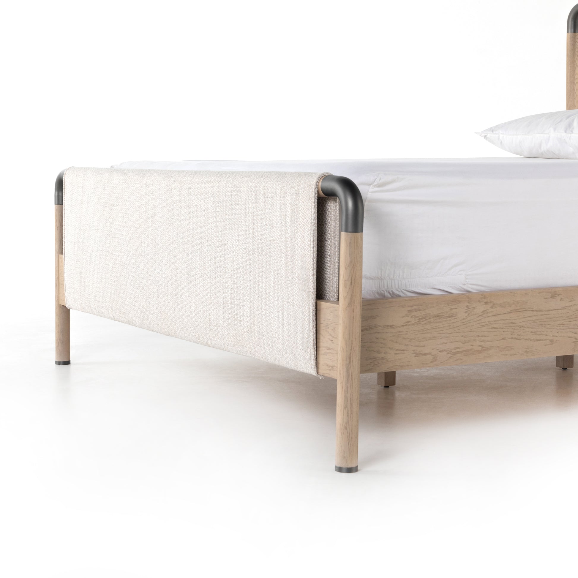 We love the mixed materials of this Harriet Bed. Framed by solid oak with rounded iron corners, an upholstered, sling-style headboard brings a light, modern vibe to any bedroom. Queen Overall Dimensions: 70.50"w x 88.50"d x 51.00"h  King Overall Dimensions: 86.50"w x 88.50"d x 51.00"h