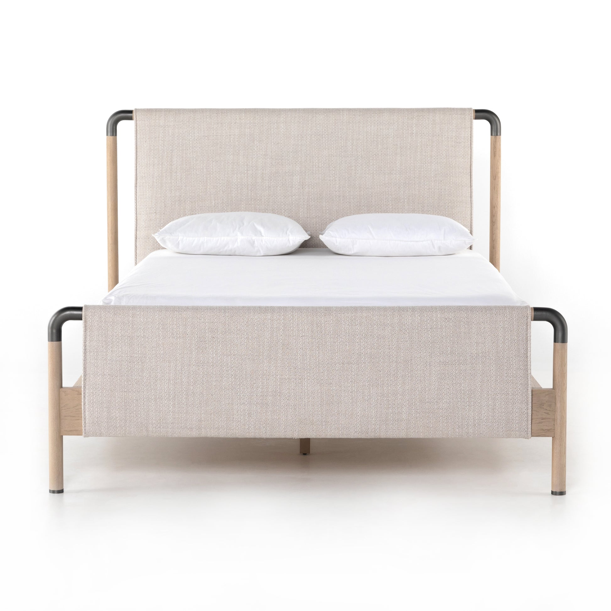 We love the mixed materials of this Harriet Bed. Framed by solid oak with rounded iron corners, an upholstered, sling-style headboard brings a light, modern vibe to any bedroom. Queen Overall Dimensions: 70.50"w x 88.50"d x 51.00"h  King Overall Dimensions: 86.50"w x 88.50"d x 51.00"h