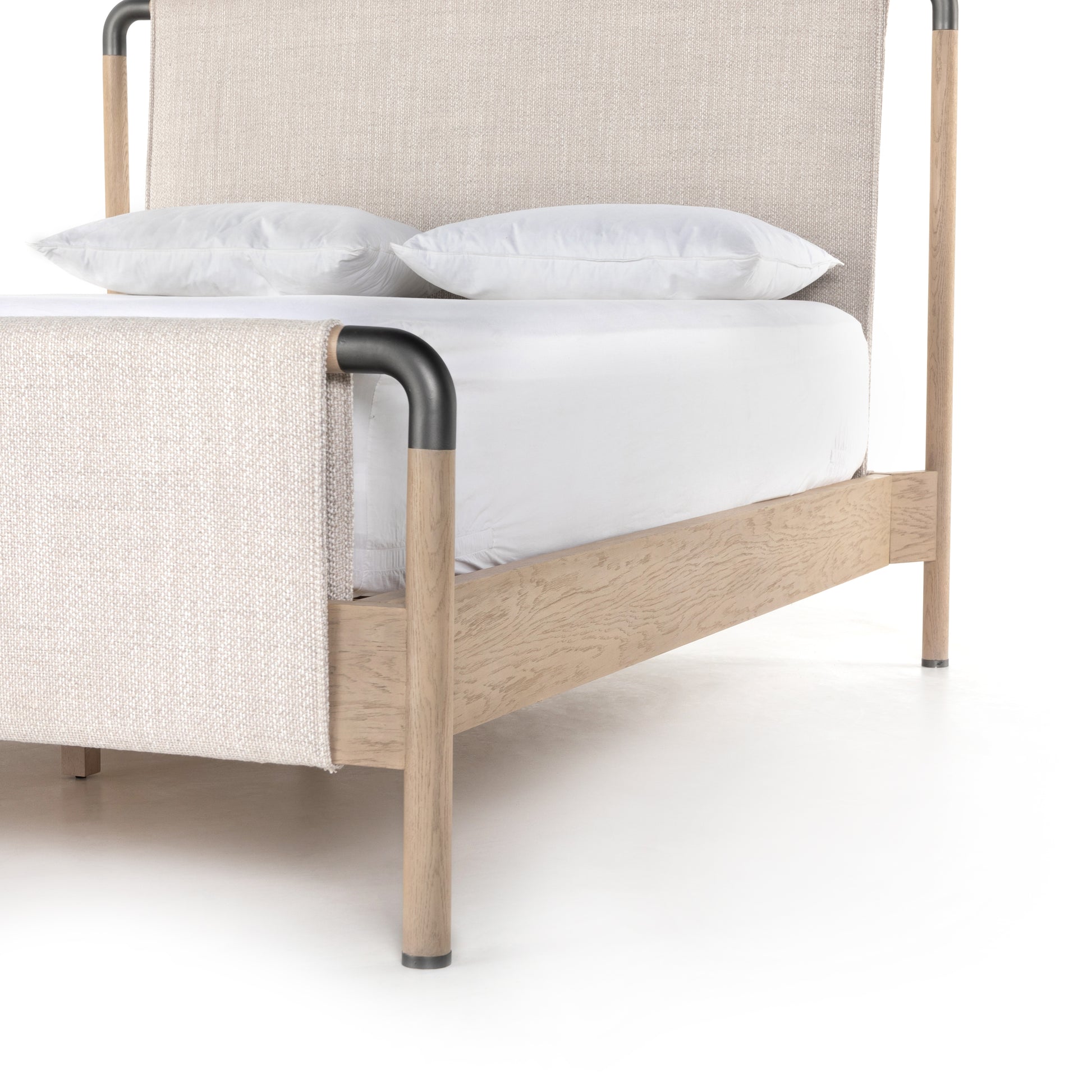 We love the mixed materials of this Harriet Bed. Framed by solid oak with rounded iron corners, an upholstered, sling-style headboard brings a light, modern vibe to any bedroom. Queen Overall Dimensions: 70.50"w x 88.50"d x 51.00"h  King Overall Dimensions: 86.50"w x 88.50"d x 51.00"h