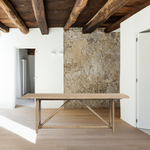 Rustic goes modern with this Mika Dining Table. A triangular stretcher brings architectural interest to this simply styled dining table of white-washed oak.  Overall Dimensions: 84.00"w x 36.00"d x 30.00"h  Colors: Whitewashed Oak Materials: Oak, Oak Veneer