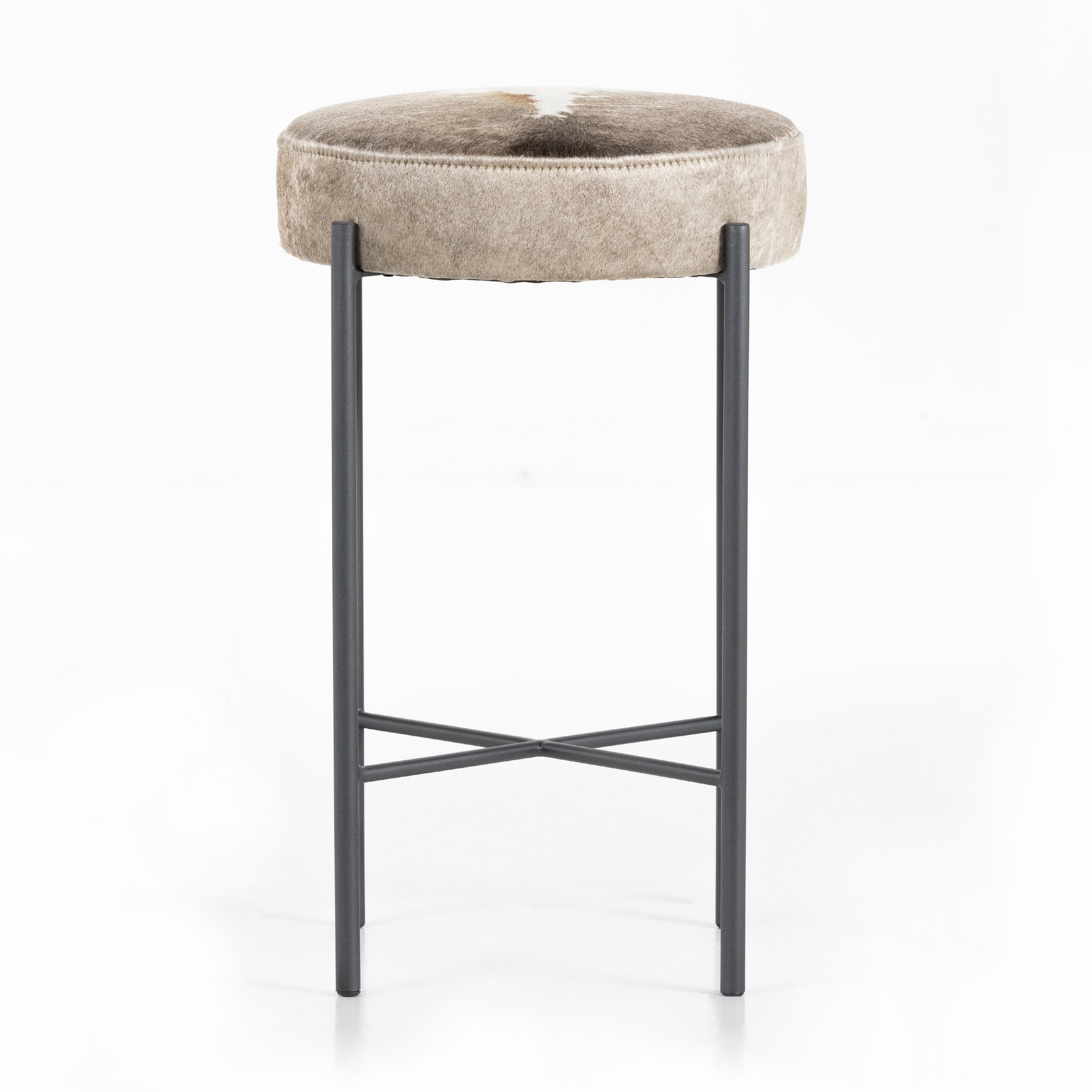 The Nocona Speckled Hide Bar and Counter stool is modern minimalist to a T. Slim and airy, gunmetal-finished iron legs form a cradle-style frame for speckled hide seating, perfectly sized for the counter or bar. Each hide will be unique and will vary. Amethyst Home provides interior design, new home construction design consulting, vintage area rugs, and lighting in the Kansas City metro area.