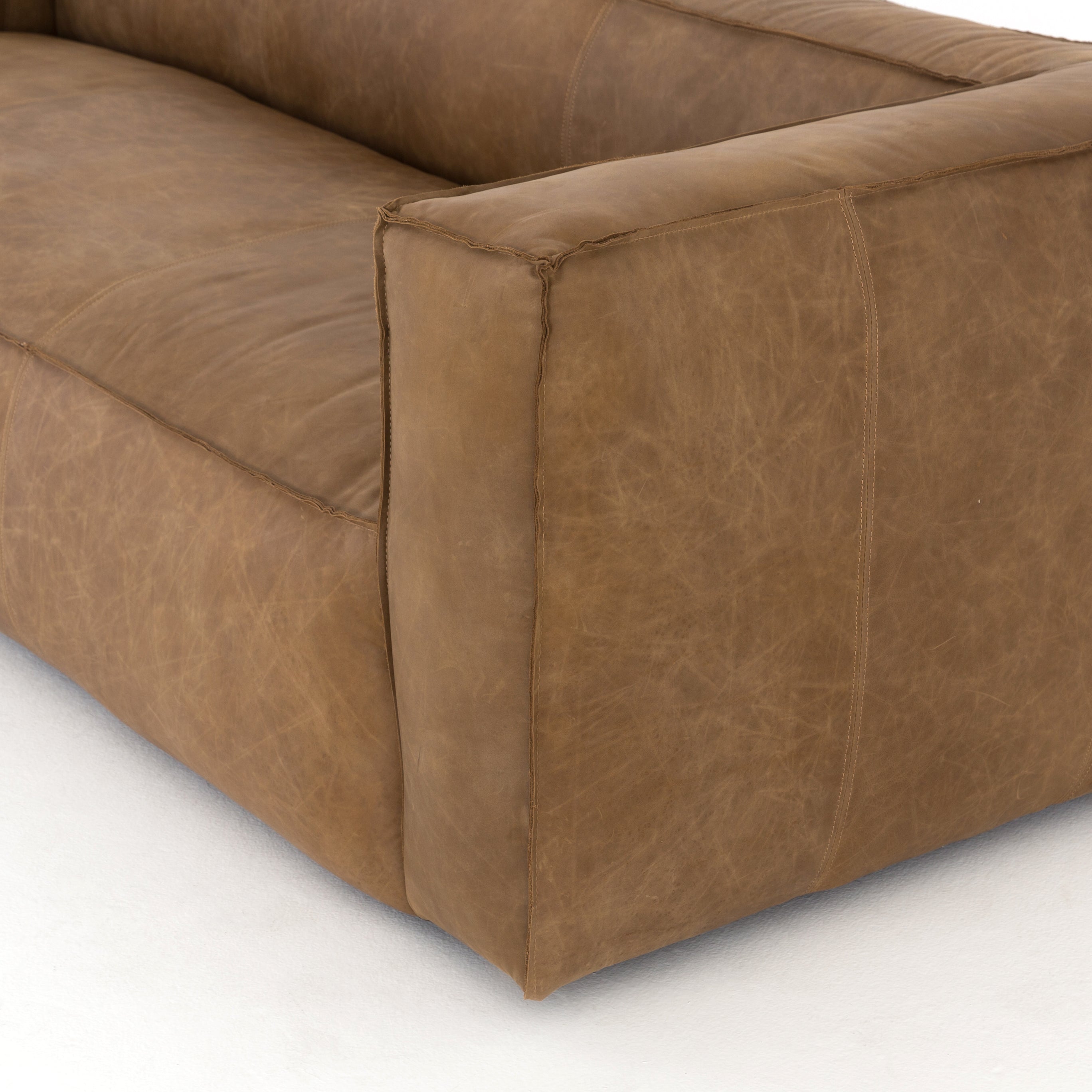 Sophisticated Italian styling with distinctly casual appeal is found in this Nolita Reverse Stitch Sofa - Natural Washed Sand. Top-grain leather takes on a natural sand color with contrast stitching along the welt, sure to elevate the space for any living room.   Overall Dimensions: 99.25"w x 43.00"d x 28.75"h