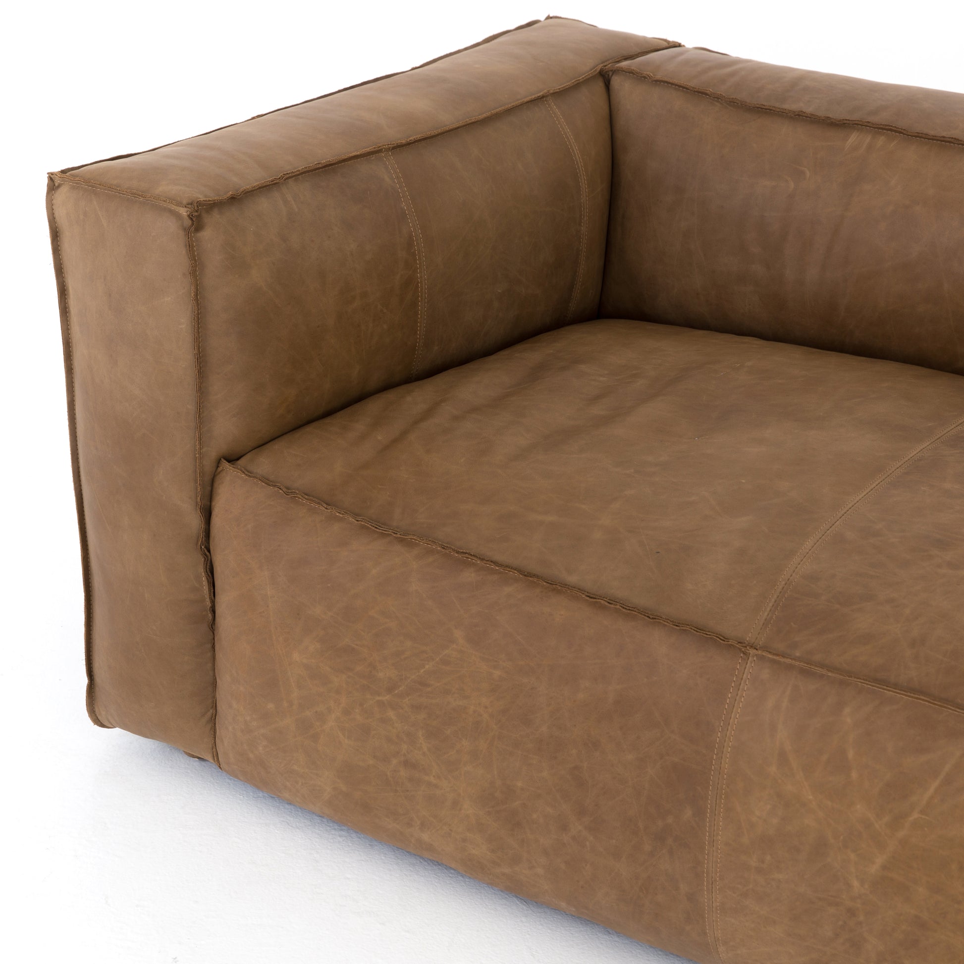 Sophisticated Italian styling with distinctly casual appeal is found in this Nolita Reverse Stitch Sofa - Natural Washed Sand. Top-grain leather takes on a natural sand color with contrast stitching along the welt, sure to elevate the space for any living room.   Overall Dimensions: 99.25"w x 43.00"d x 28.75"h