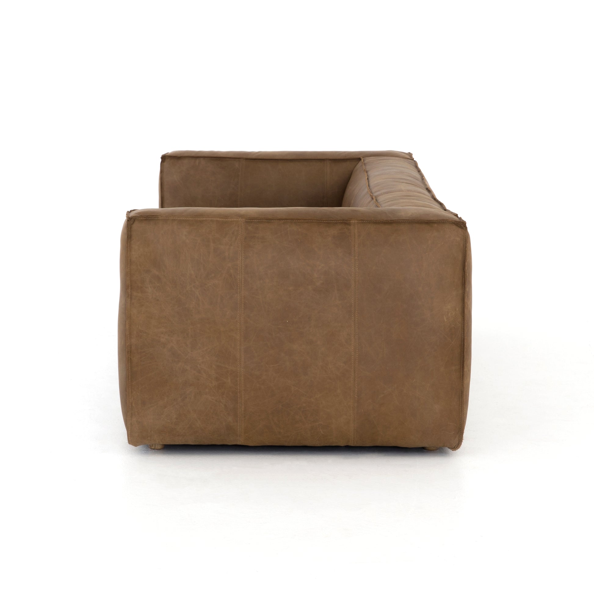 Sophisticated Italian styling with distinctly casual appeal is found in this Nolita Reverse Stitch Sofa - Natural Washed Sand. Top-grain leather takes on a natural sand color with contrast stitching along the welt, sure to elevate the space for any living room.   Overall Dimensions: 99.25"w x 43.00"d x 28.75"h