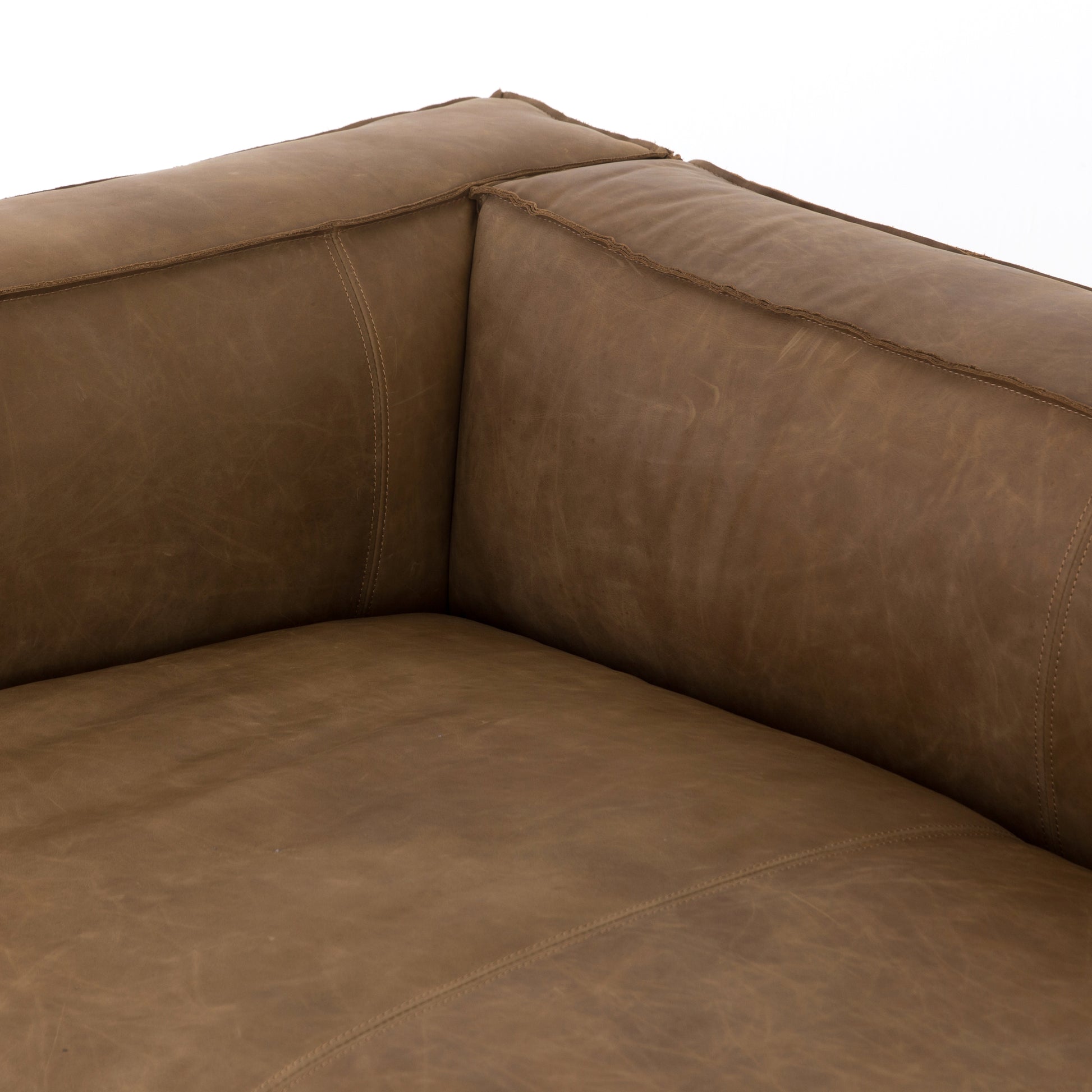 Sophisticated Italian styling with distinctly casual appeal is found in this Nolita Reverse Stitch Sofa - Natural Washed Sand. Top-grain leather takes on a natural sand color with contrast stitching along the welt, sure to elevate the space for any living room.   Overall Dimensions: 99.25"w x 43.00"d x 28.75"h