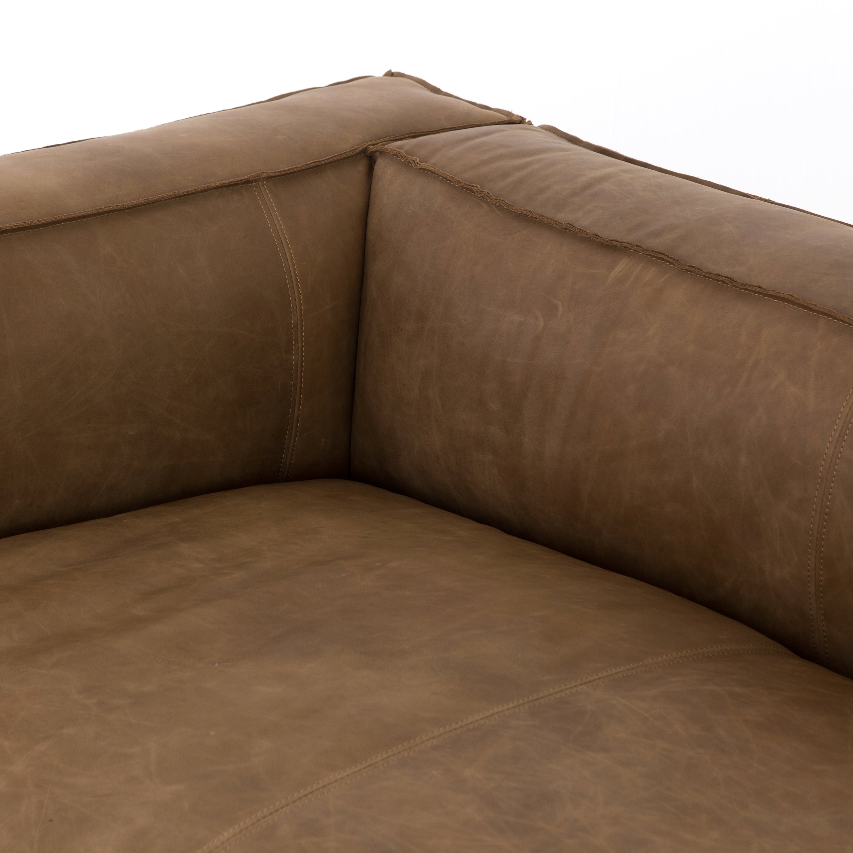 Sophisticated Italian styling with distinctly casual appeal is found in this Nolita Reverse Stitch Sofa - Natural Washed Sand. Top-grain leather takes on a natural sand color with contrast stitching along the welt, sure to elevate the space for any living room.   Overall Dimensions: 99.25"w x 43.00"d x 28.75"h