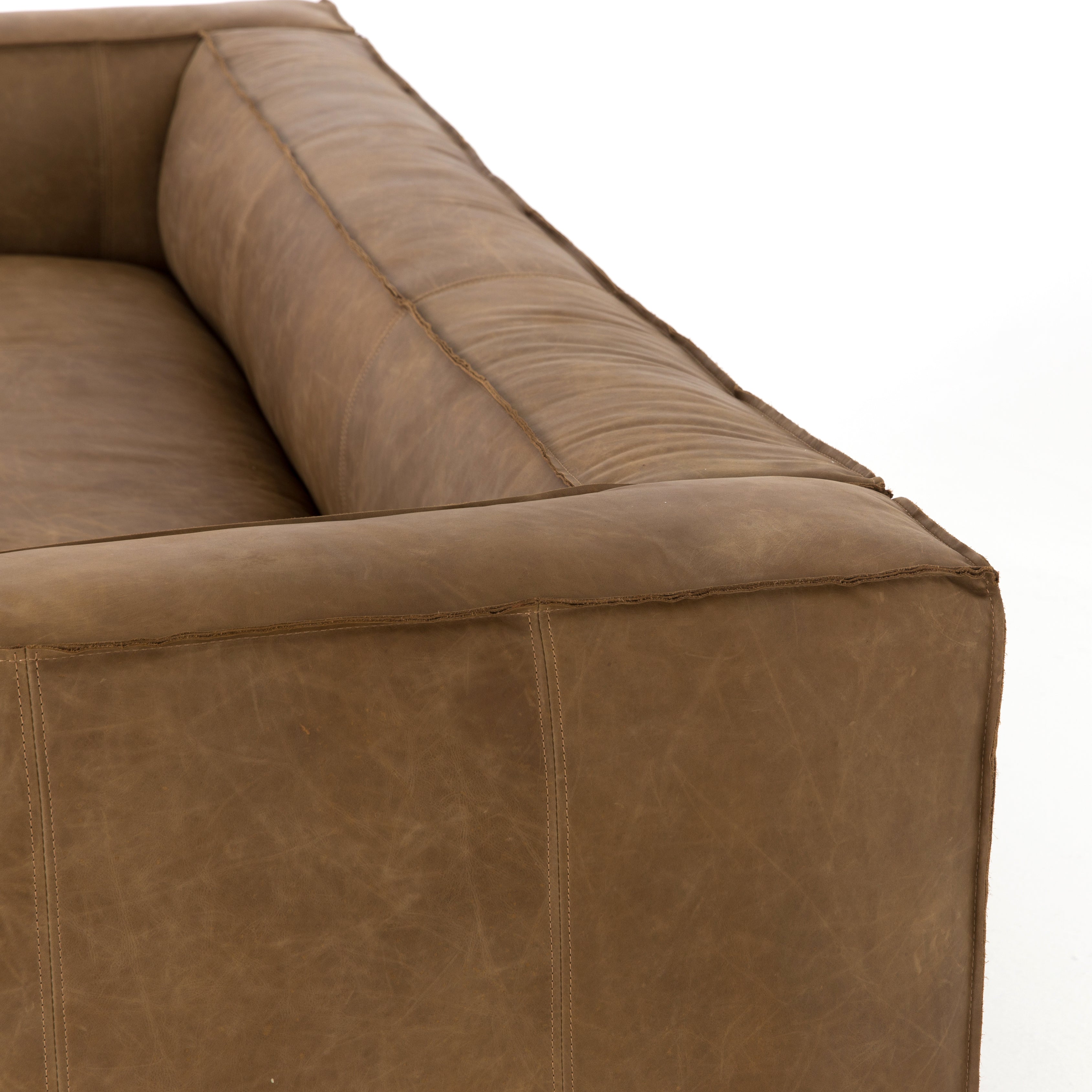 Sophisticated Italian styling with distinctly casual appeal is found in this Nolita Reverse Stitch Sofa - Natural Washed Sand. Top-grain leather takes on a natural sand color with contrast stitching along the welt, sure to elevate the space for any living room.   Overall Dimensions: 99.25"w x 43.00"d x 28.75"h