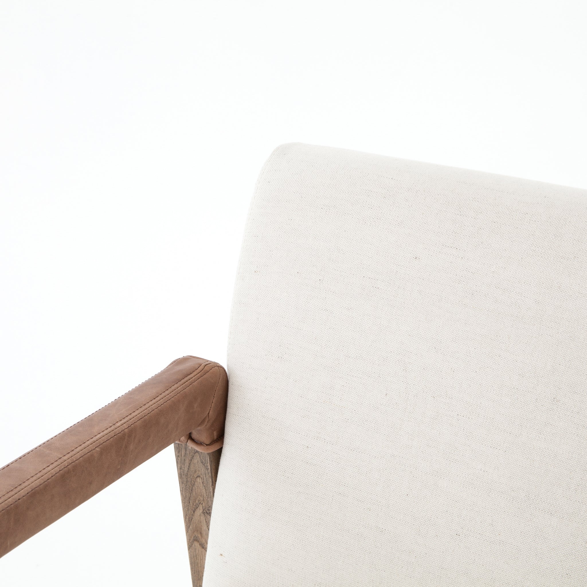 Elegance is no exaggeration with this Reuben Dining Chair - Harbor Natural. Slim, tapered oak with arms wrapped in vintage leather frames a floating seat covered in natural linen. We'd love to see this in your dining room, kitchen, or other space!  Overall Dimensions: 23.25"w x 25.50"d x 33.75"h