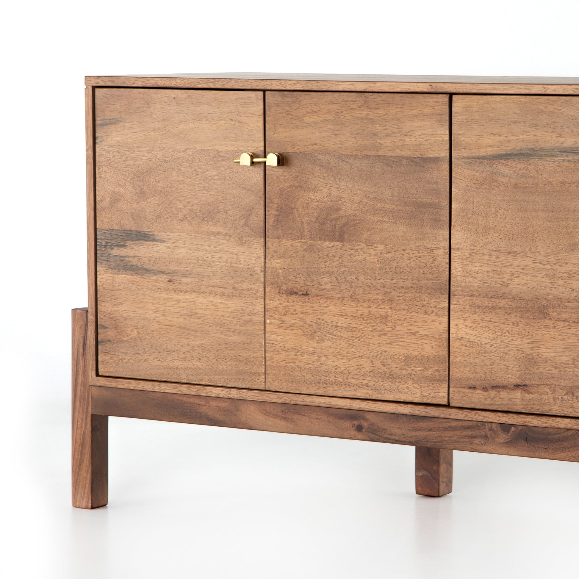 We love mid-century feel to this Reza Media Console - Smoked Honey. Finished in a light, smoked honey, a clean-lined parawood console sits in an arched cradle base of toasted acacia, for fresh contrast. Twist-lock metal hardware adds a clever finishing touch. Rear cutouts for media cord management.  Overall Dimensions: 84.00"w x 18.00"d x 28.25"h