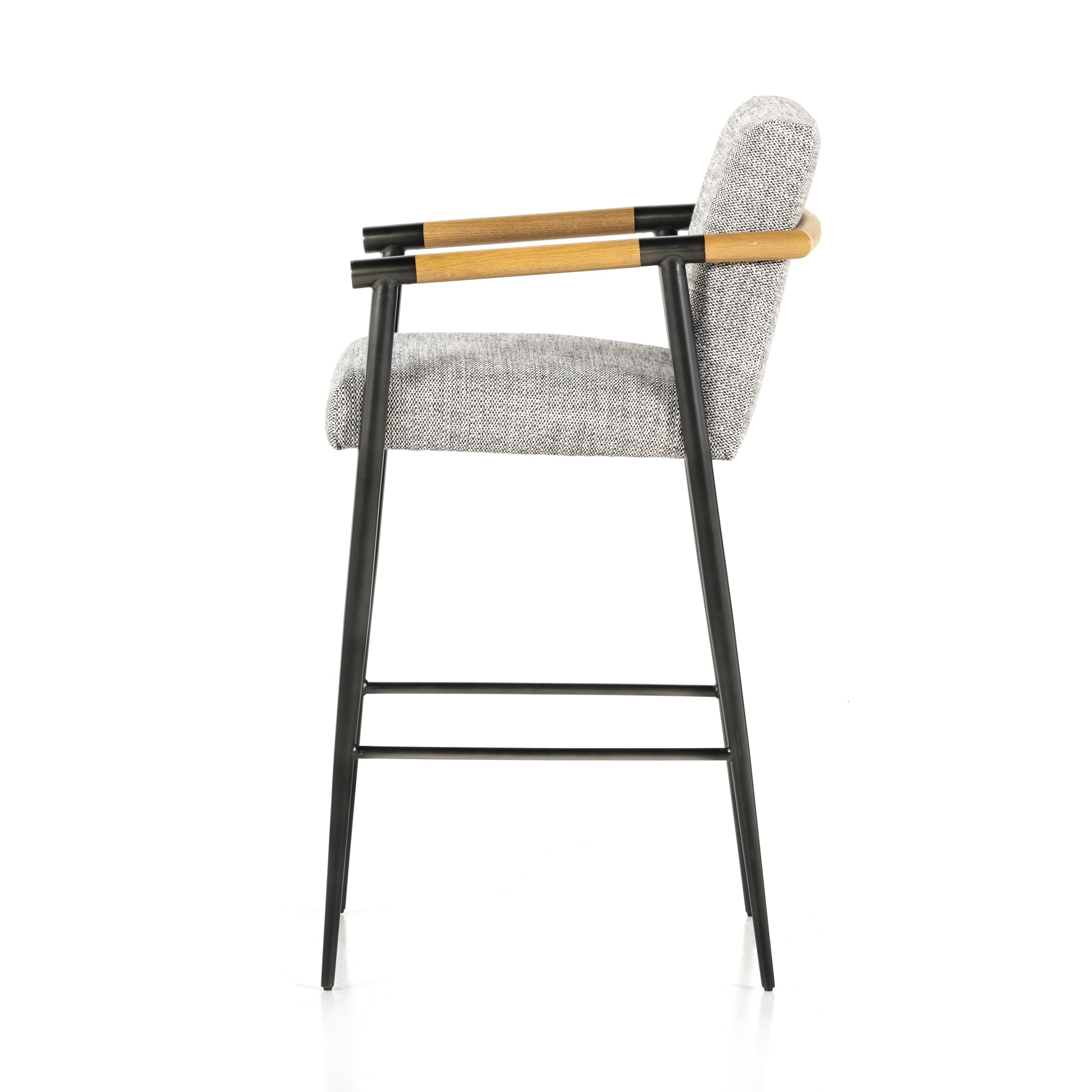We love the textural grey seating upholstered in a high-performance fabric on this Rowen Bar + Counter Stool - Thames Raven. The angular solid oak arms and black-finished stainless steel framing is perfectly sized to elevate your bar or counter space. 