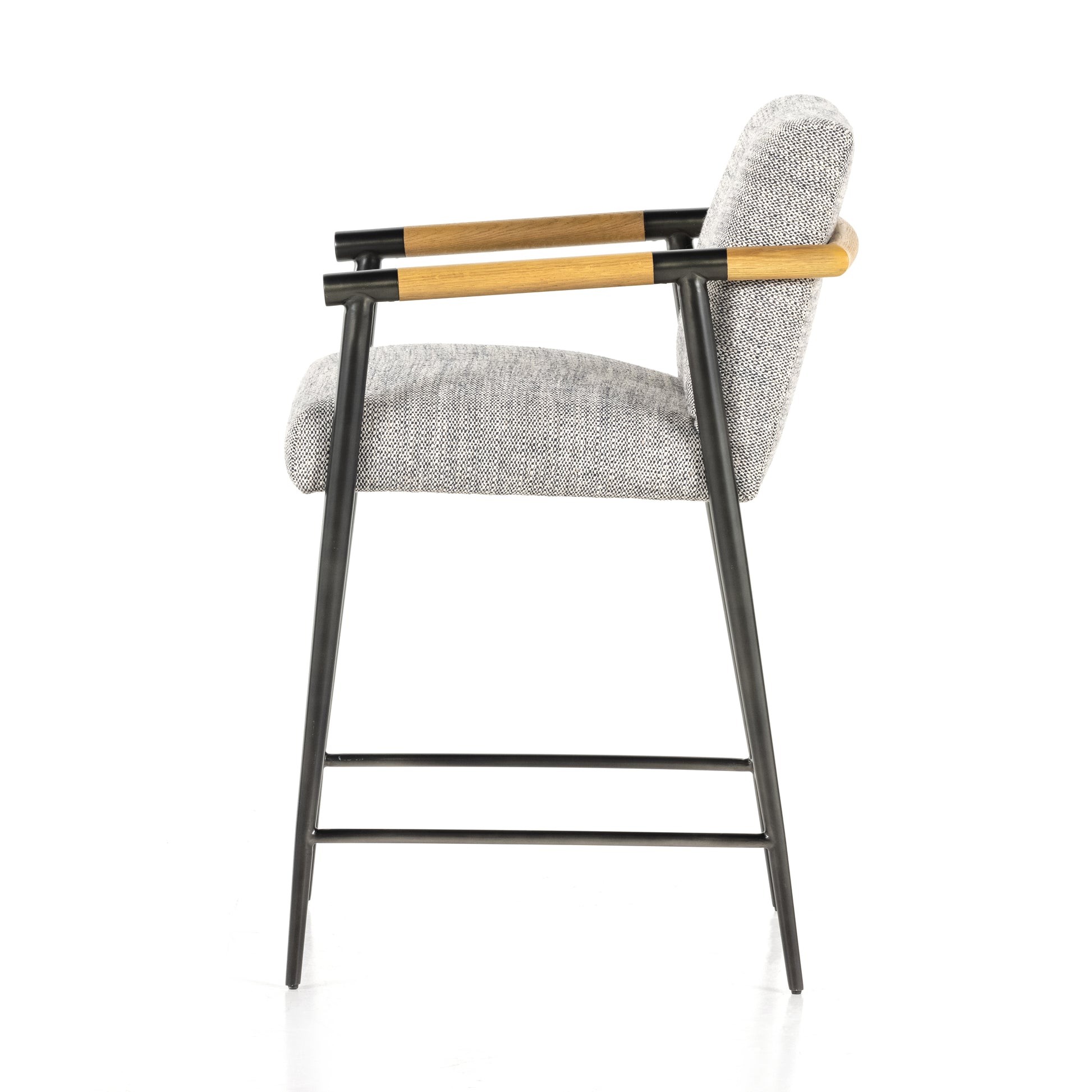 We love the textural grey seating upholstered in a high-performance fabric on this Rowen Bar + Counter Stool - Thames Raven. The angular solid oak arms and black-finished stainless steel framing is perfectly sized to elevate your bar or counter space. 