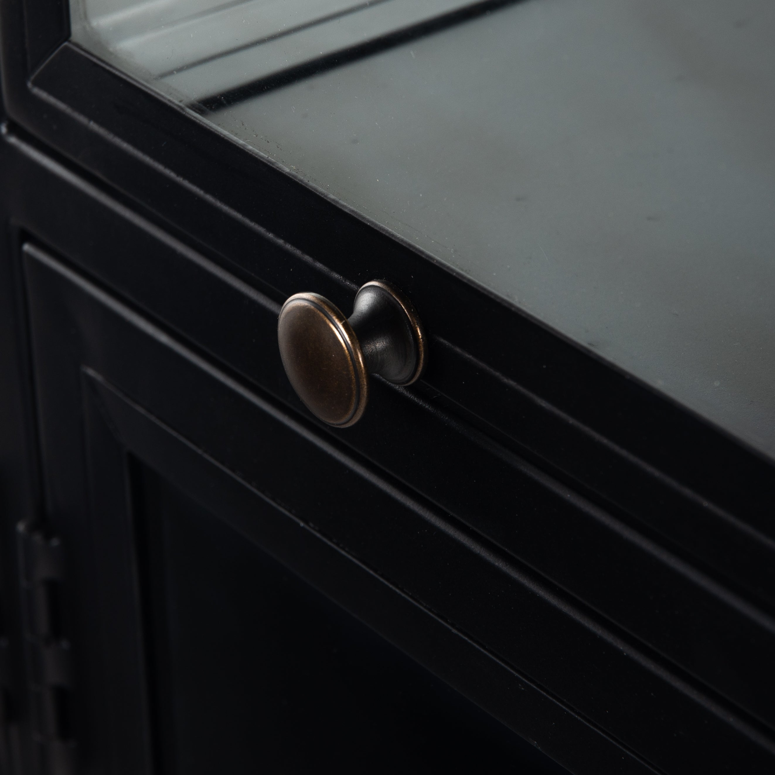This Shadow Box Sideboard gives your inner collector a place to play. Store prized possessions behind clear glass fronts, with black-finished metal casing and brass hardware for contrast.  Overall Dimensions: 70.00"w x 17.25"d x 35.00"h