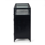 Featuring Shadow Box Sideboard - Black by Four Hands at Amethyst Home. This Shadow Box Sideboard gives your inner collector a place to play. Store prized possessions behind clear glass fronts, with black-finished metal casing and brass hardware for contrast.
Overall Dimensions: 70"W x 17.25"L x 35"H
Colors: Black, Weathered Bronze, Clear Glass, Tempered.  Amethyst Home provides interior design, new home construction design consulting, vintage area rugs, and lighting in the Laguna Beach metro area.