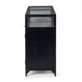 Featuring Shadow Box Sideboard - Black by Four Hands at Amethyst Home. This Shadow Box Sideboard gives your inner collector a place to play. Store prized possessions behind clear glass fronts, with black-finished metal casing and brass hardware for contrast.
Overall Dimensions: 70"W x 17.25"L x 35"H
Colors: Black, Weathered Bronze, Clear Glass, Tempered.  Amethyst Home provides interior design, new home construction design consulting, vintage area rugs, and lighting in the Laguna Beach metro area.