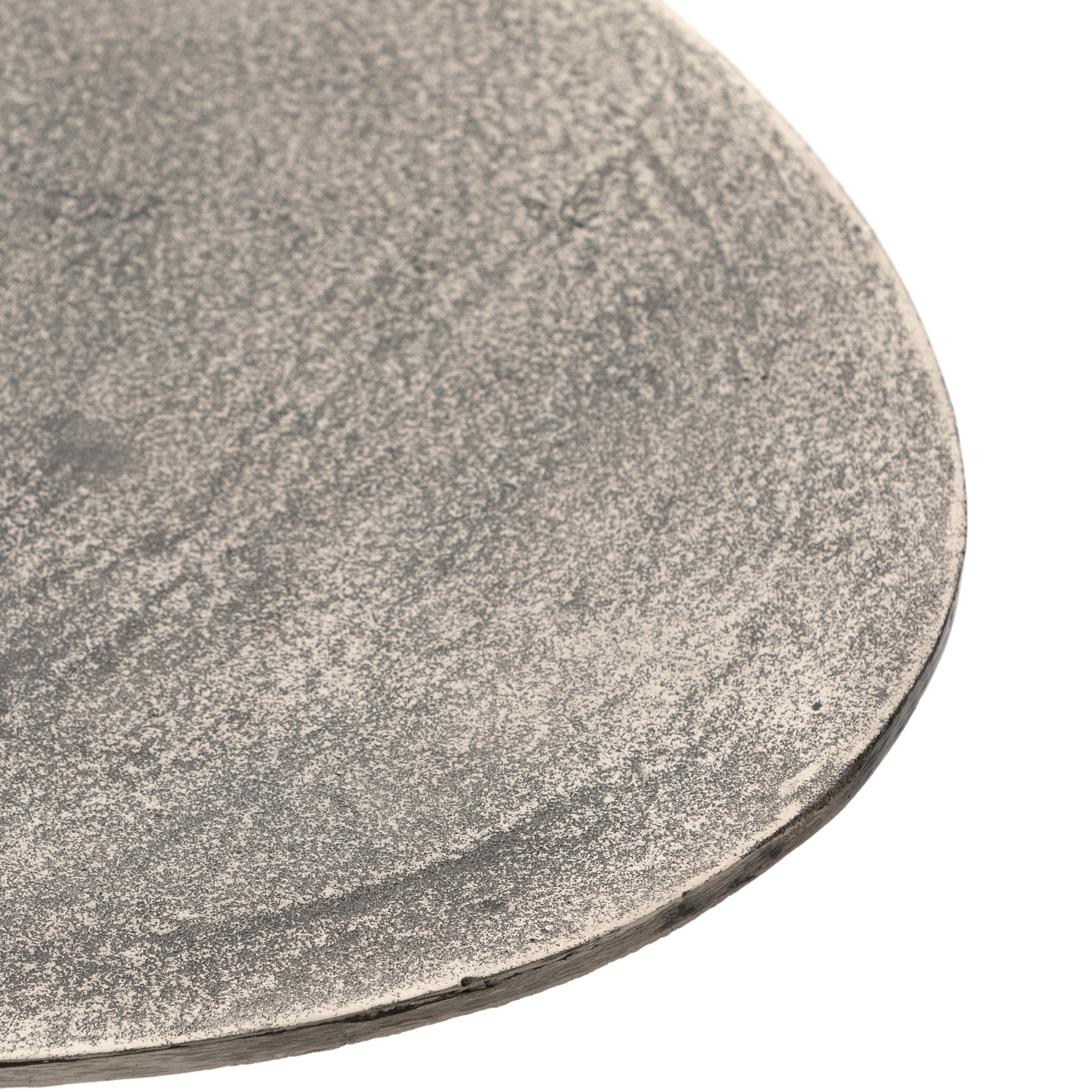 We love the oval shape of this Simone Coffee Table - Antique Nickel. The textural cast aluminum makes for a beautifully modern coffee table, with alluring highs and lows played up by a raw nickel finish. Great indoors or out; cover or store indoors during inclement weather and when not in use.  Overall Dimensions: 54.75"w x 29.25"d x 16.50"h