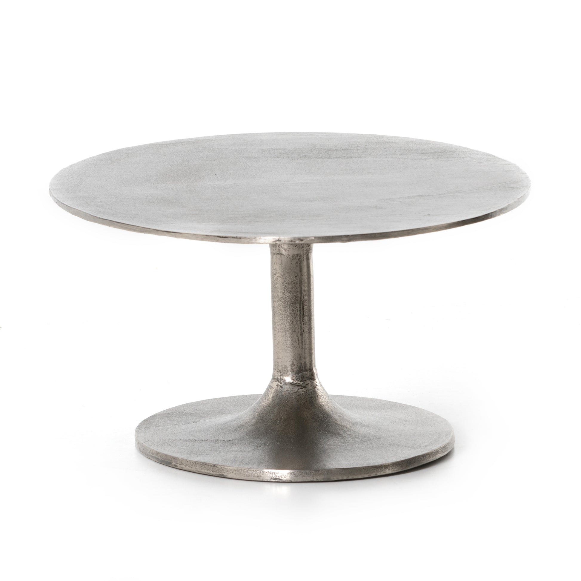 We love the oval shape of this Simone Coffee Table - Antique Nickel. The textural cast aluminum makes for a beautifully modern coffee table, with alluring highs and lows played up by a raw nickel finish. Great indoors or out; cover or store indoors during inclement weather and when not in use.  Overall Dimensions: 54.75"w x 29.25"d x 16.50"h