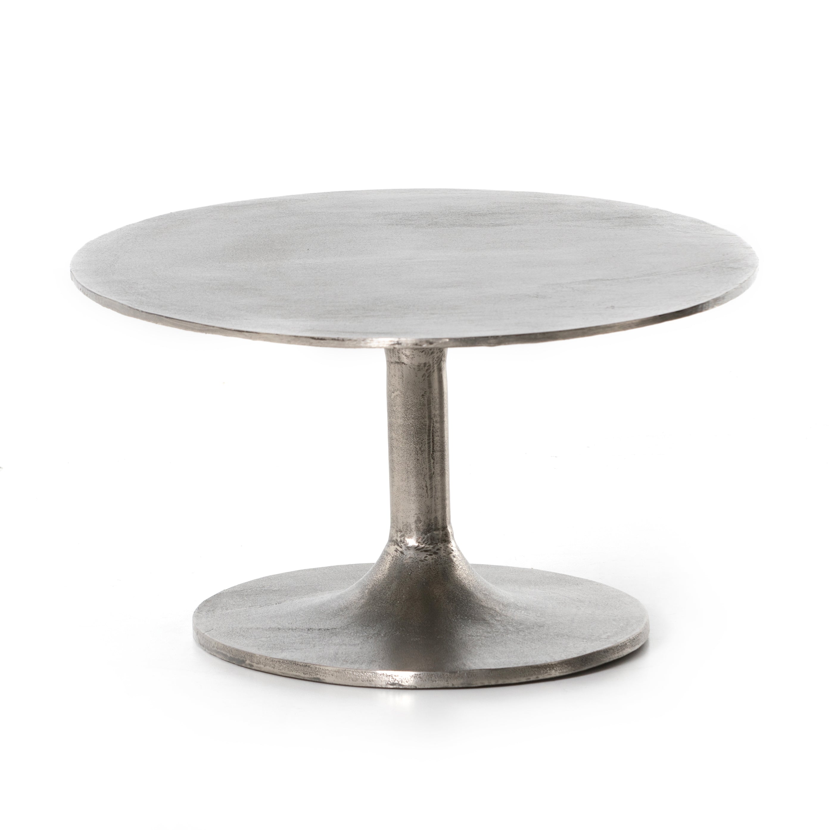 We love the oval shape of this Simone Coffee Table - Antique Nickel. The textural cast aluminum makes for a beautifully modern coffee table, with alluring highs and lows played up by a raw nickel finish. Great indoors or out; cover or store indoors during inclement weather and when not in use.  Overall Dimensions: 54.75"w x 29.25"d x 16.50"h