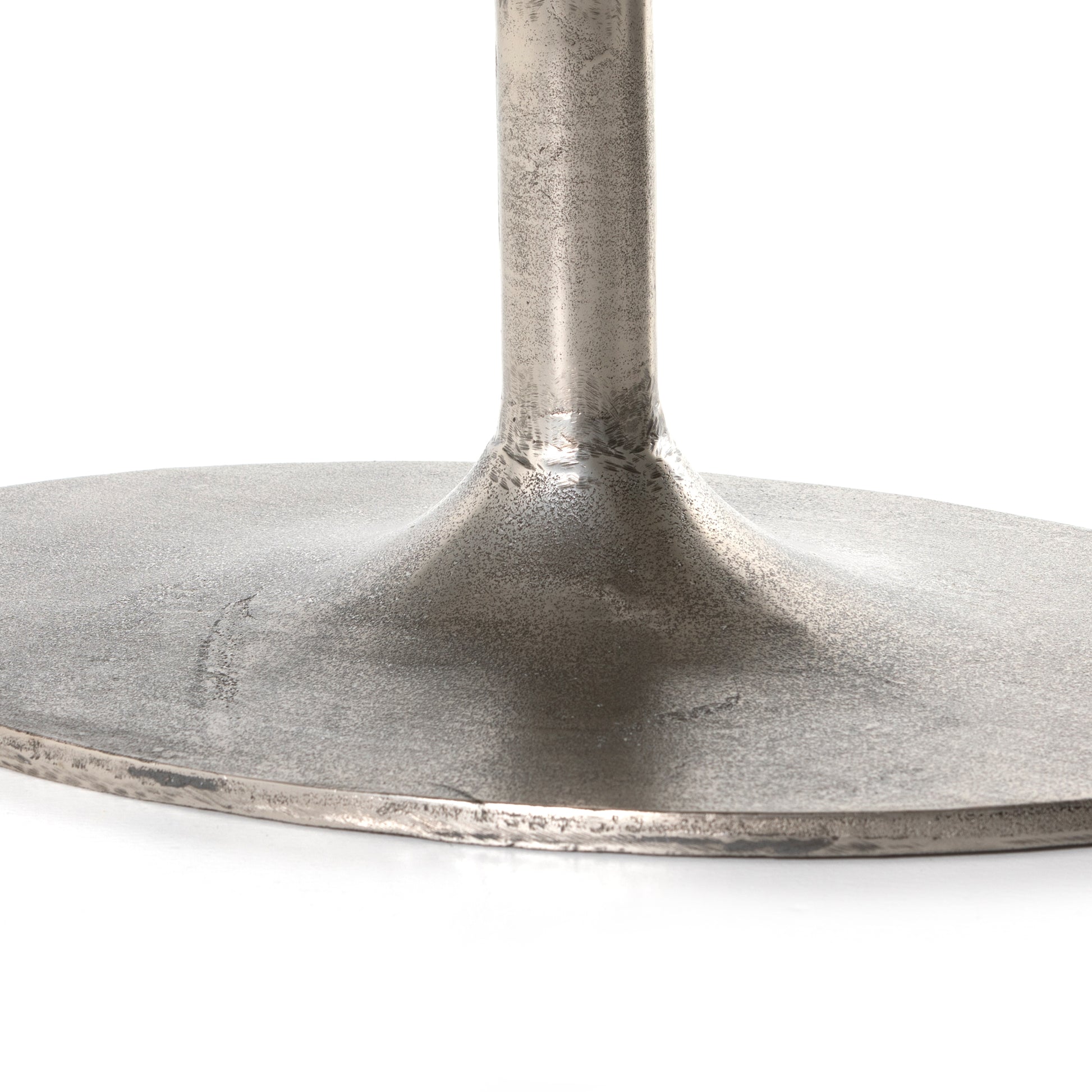 We love the oval shape of this Simone Coffee Table - Antique Nickel. The textural cast aluminum makes for a beautifully modern coffee table, with alluring highs and lows played up by a raw nickel finish. Great indoors or out; cover or store indoors during inclement weather and when not in use.  Overall Dimensions: 54.75"w x 29.25"d x 16.50"h
