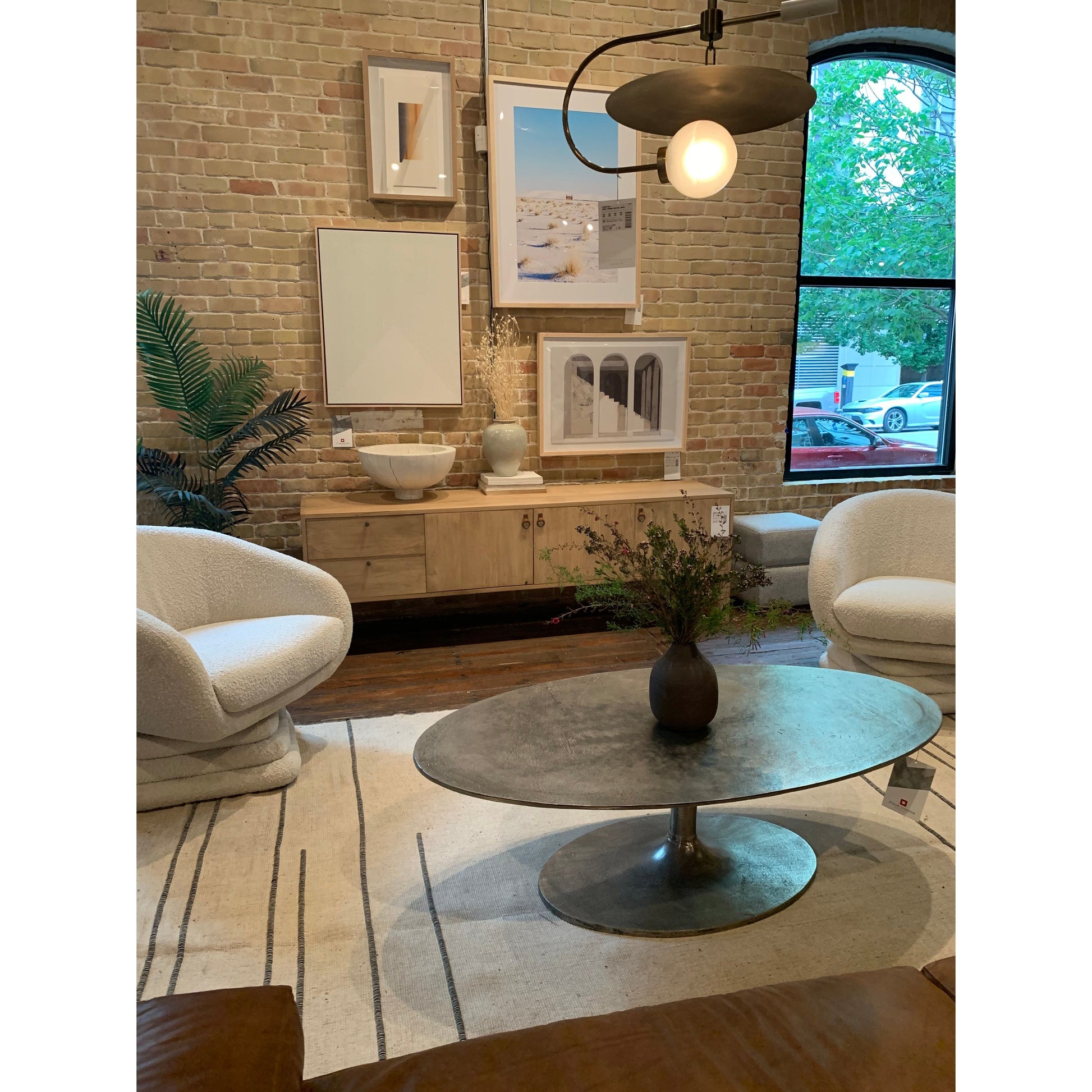We love the oval shape of this Simone Coffee Table - Antique Nickel. The textural cast aluminum makes for a beautifully modern coffee table, with alluring highs and lows played up by a raw nickel finish. Great indoors or out; cover or store indoors during inclement weather and when not in use.  Overall Dimensions: 54.75"w x 29.25"d x 16.50"h