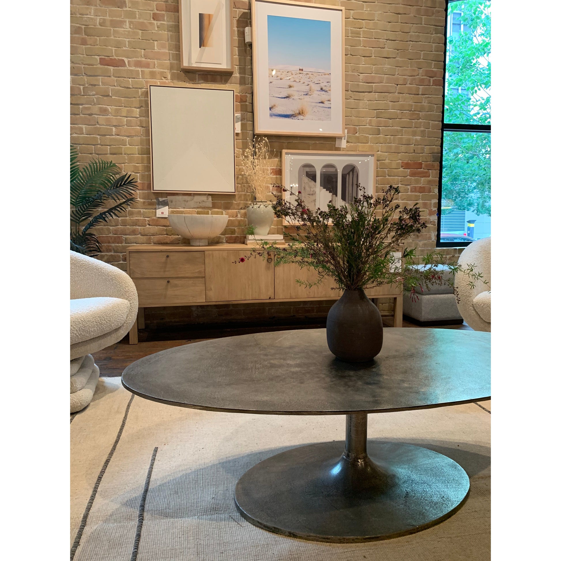 We love the oval shape of this Simone Coffee Table - Antique Nickel. The textural cast aluminum makes for a beautifully modern coffee table, with alluring highs and lows played up by a raw nickel finish. Great indoors or out; cover or store indoors during inclement weather and when not in use.  Overall Dimensions: 54.75"w x 29.25"d x 16.50"h