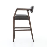 Featuring Tyler Chaps Ebony Counter Stool by Four Hands at Amethyst Home. The Tyler Counter Stool in Chaps Ebony makes counter seating stylish with an angular, dark and smoky birch frame, a deep seat, and a striking, low-slung back. The stool is comfortable for long dinners and conversations with a covered black, top-grain leather seat and back.
Counter S.  Amethyst Home provides interior design, new home construction design consulting, vintage area rugs, and lighting in the Scottsdale metro area.