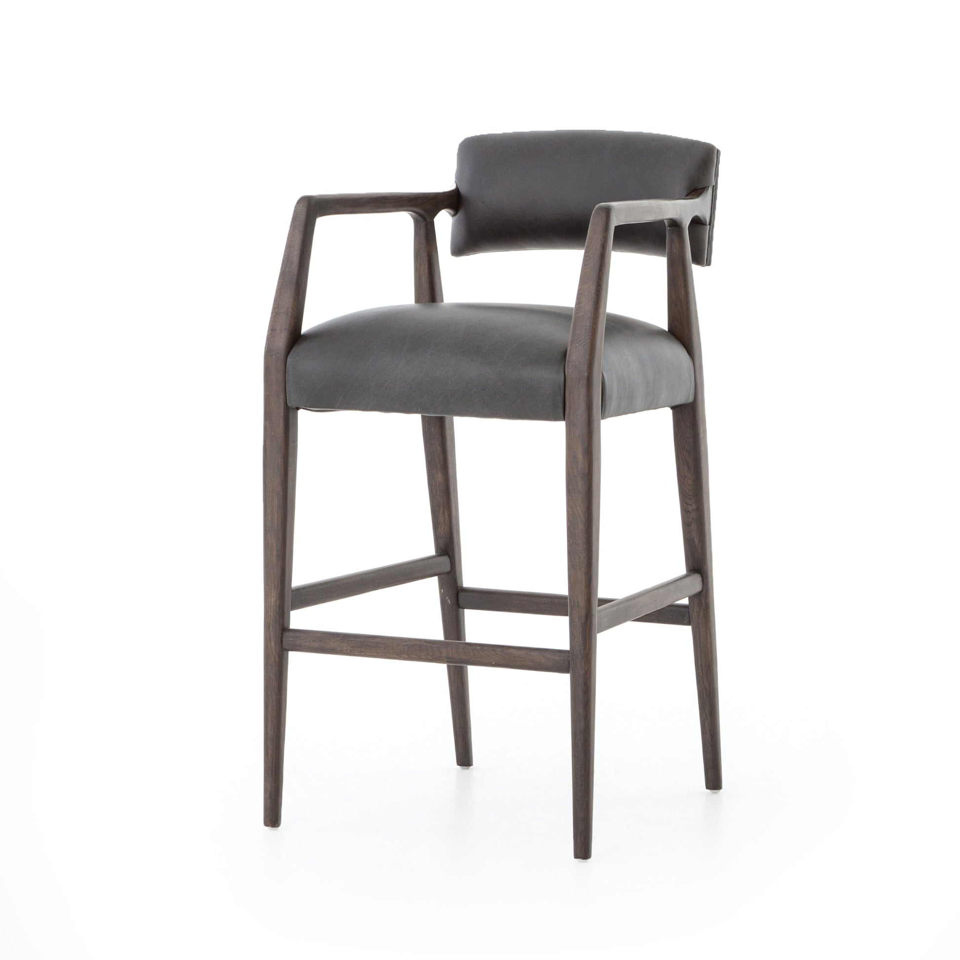 The Tyler Bar + Counter Stool - Ebony makes counter seating stylish with an angular, dark and smoky birch frame, a deep seat, and a striking, low-slung back. The stool is comfortable for long dinners and conversations with a covered black, top-grain leather seat and back.