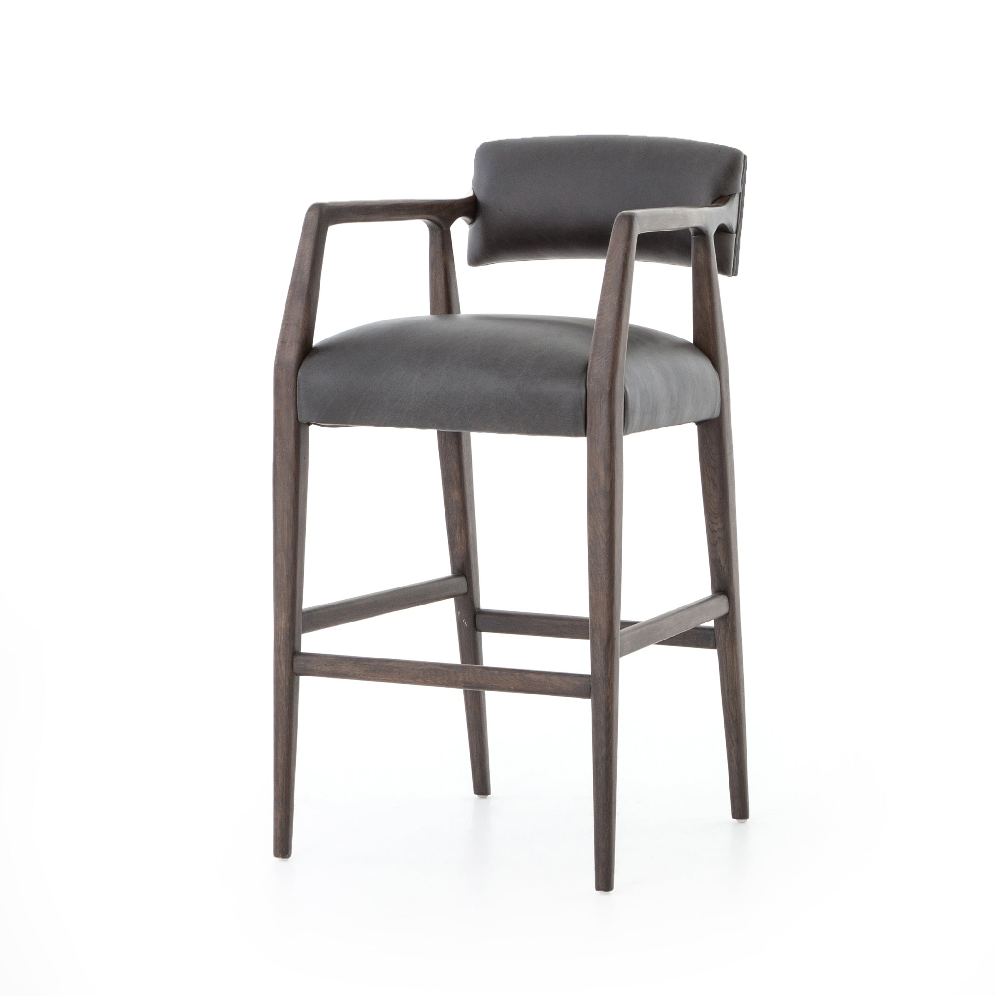 The Tyler Bar + Counter Stool - Ebony makes counter seating stylish with an angular, dark and smoky birch frame, a deep seat, and a striking, low-slung back. The stool is comfortable for long dinners and conversations with a covered black, top-grain leather seat and back.