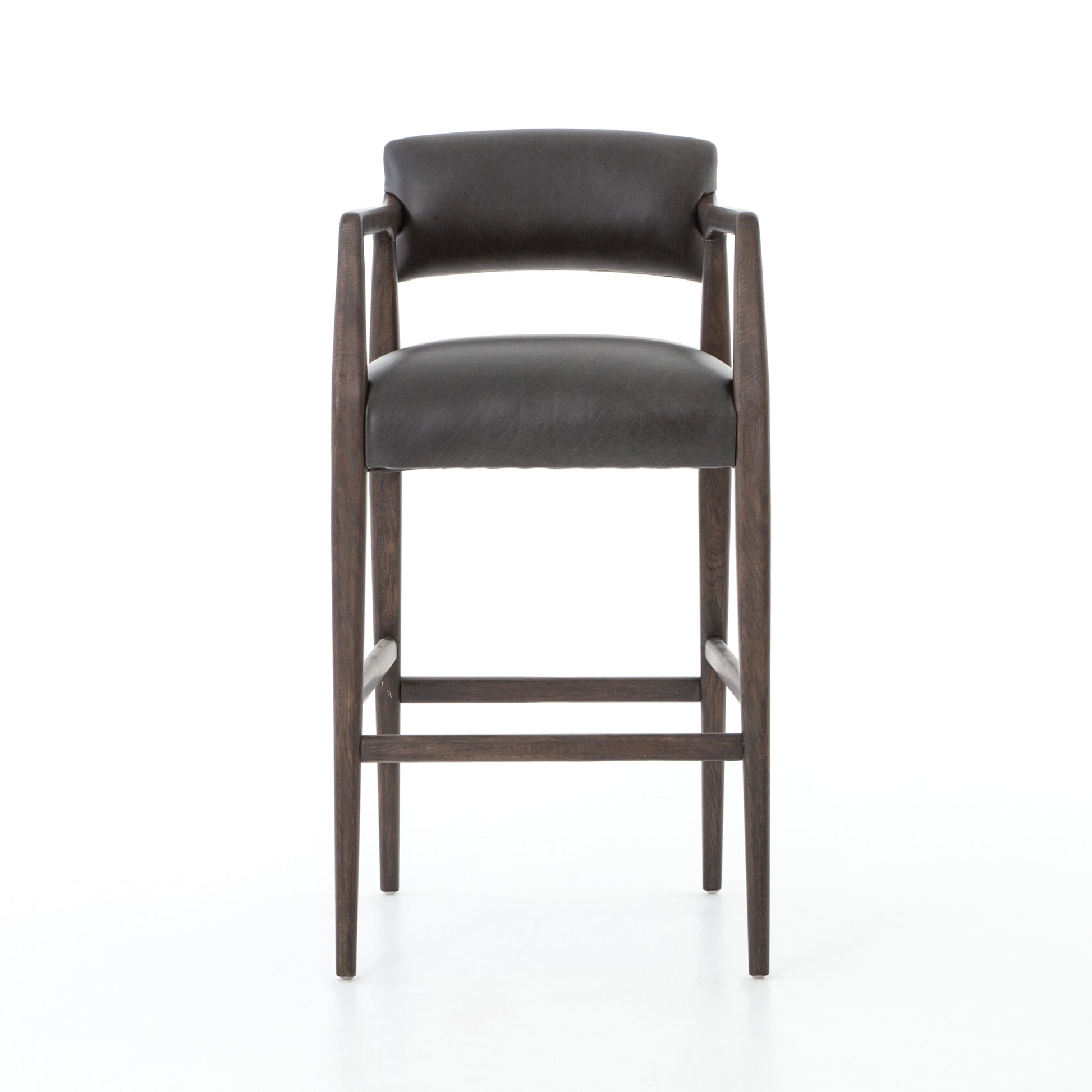 The Tyler Bar + Counter Stool - Ebony makes counter seating stylish with an angular, dark and smoky birch frame, a deep seat, and a striking, low-slung back. The stool is comfortable for long dinners and conversations with a covered black, top-grain leather seat and back.