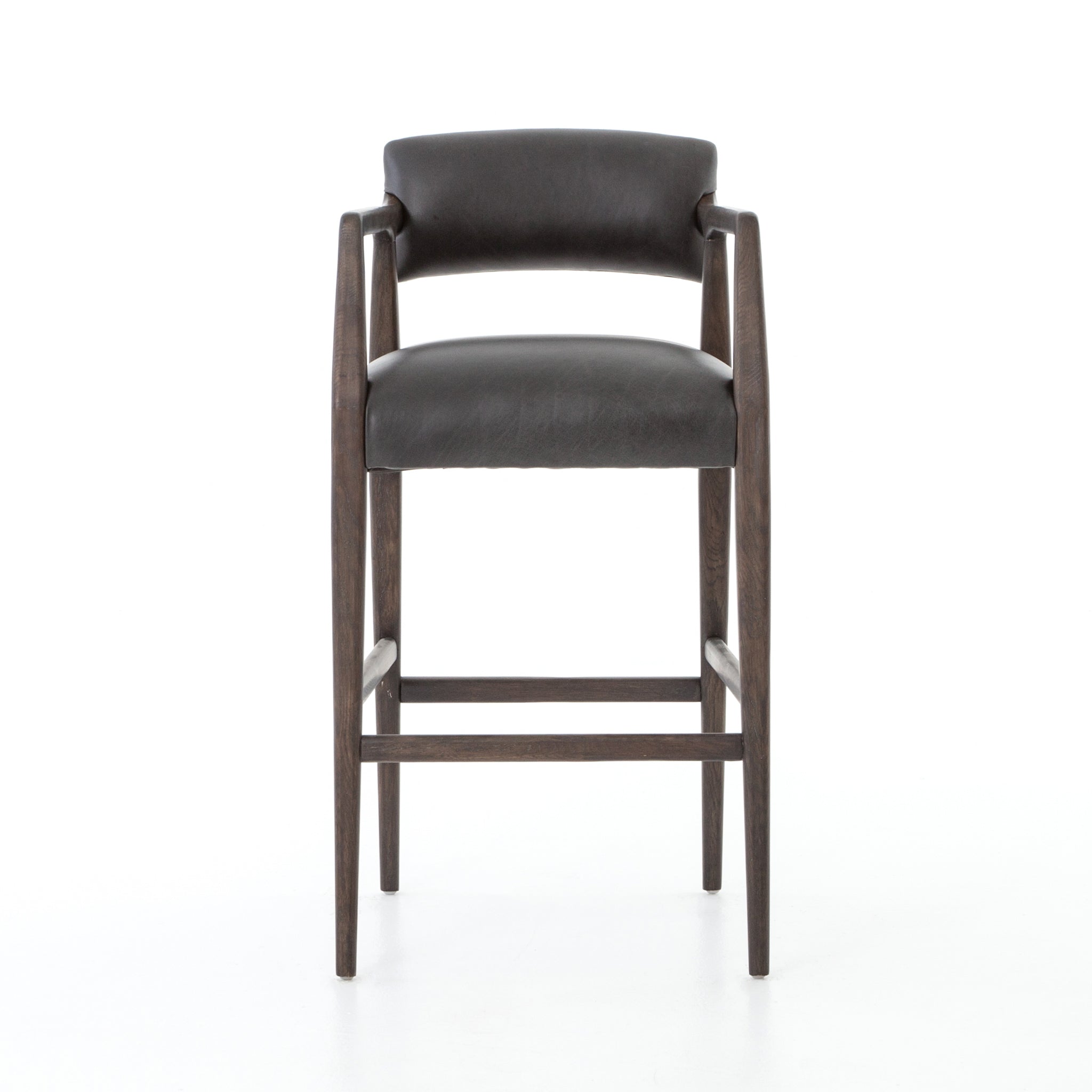 The Tyler Bar + Counter Stool - Ebony makes counter seating stylish with an angular, dark and smoky birch frame, a deep seat, and a striking, low-slung back. The stool is comfortable for long dinners and conversations with a covered black, top-grain leather seat and back.