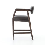Featuring Tyler Chaps Ebony Counter Stool by Four Hands at Amethyst Home. The Tyler Counter Stool in Chaps Ebony makes counter seating stylish with an angular, dark and smoky birch frame, a deep seat, and a striking, low-slung back. The stool is comfortable for long dinners and conversations with a covered black, top-grain leather seat and back.
Counter Stool.  Amethyst Home provides interior design, new home construction design consulting, vintage area rugs, and lighting in the Boston metro area.