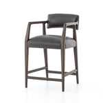 Featuring Tyler Chaps Ebony Counter Stool by Four Hands at Amethyst Home. The Tyler Counter Stool in Chaps Ebony makes counter seating stylish with an angular, dark and smoky birch frame, a deep seat, and a striking, low-slung back. The stool is comfortable for long dinners and conversations with a covered black, top-grain leather seat and back.
Counter Stool.  Amethyst Home provides interior design, new home construction design consulting, vintage area rugs, and lighting in the Austin metro area.