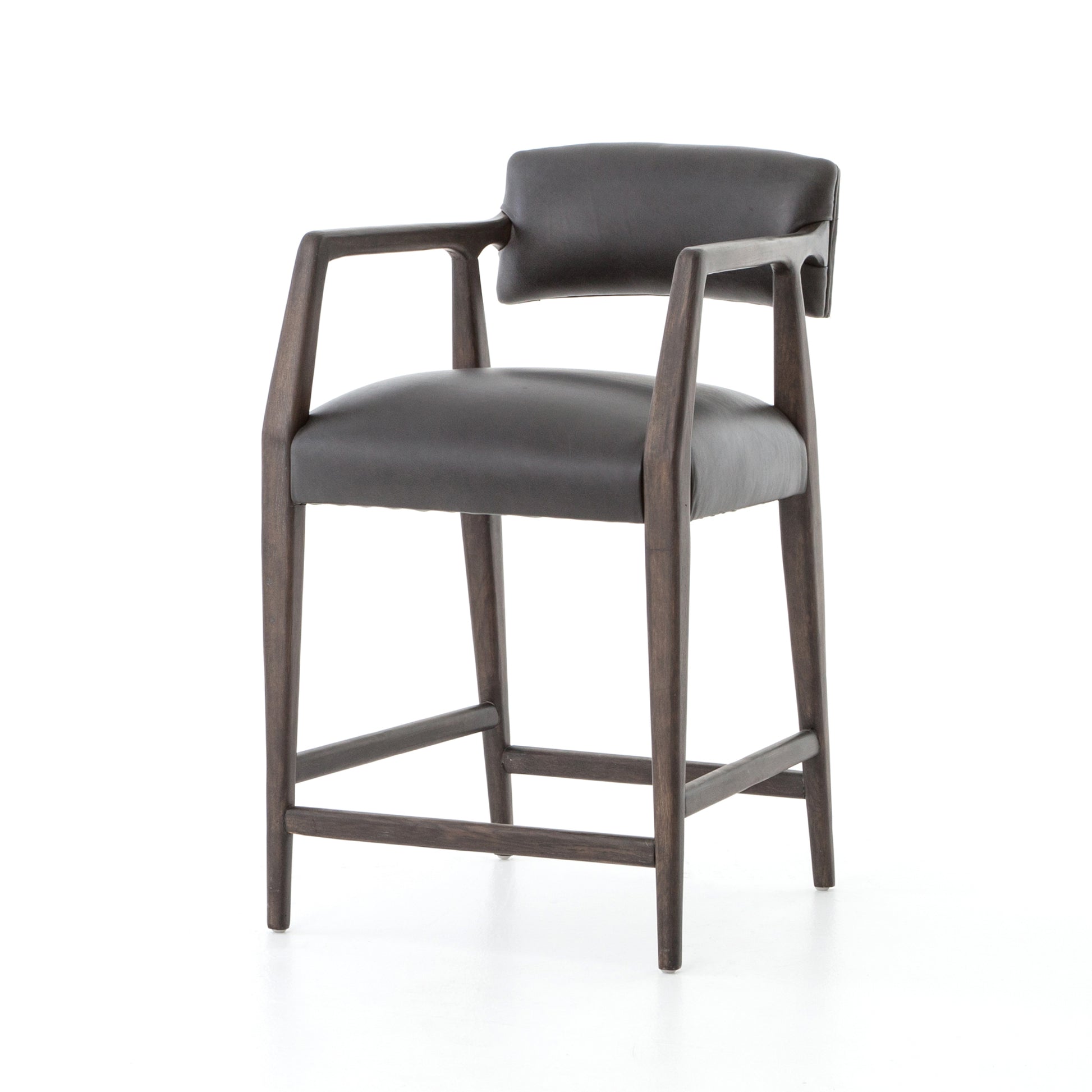 The Tyler Bar + Counter Stool - Ebony makes counter seating stylish with an angular, dark and smoky birch frame, a deep seat, and a striking, low-slung back. The stool is comfortable for long dinners and conversations with a covered black, top-grain leather seat and back.