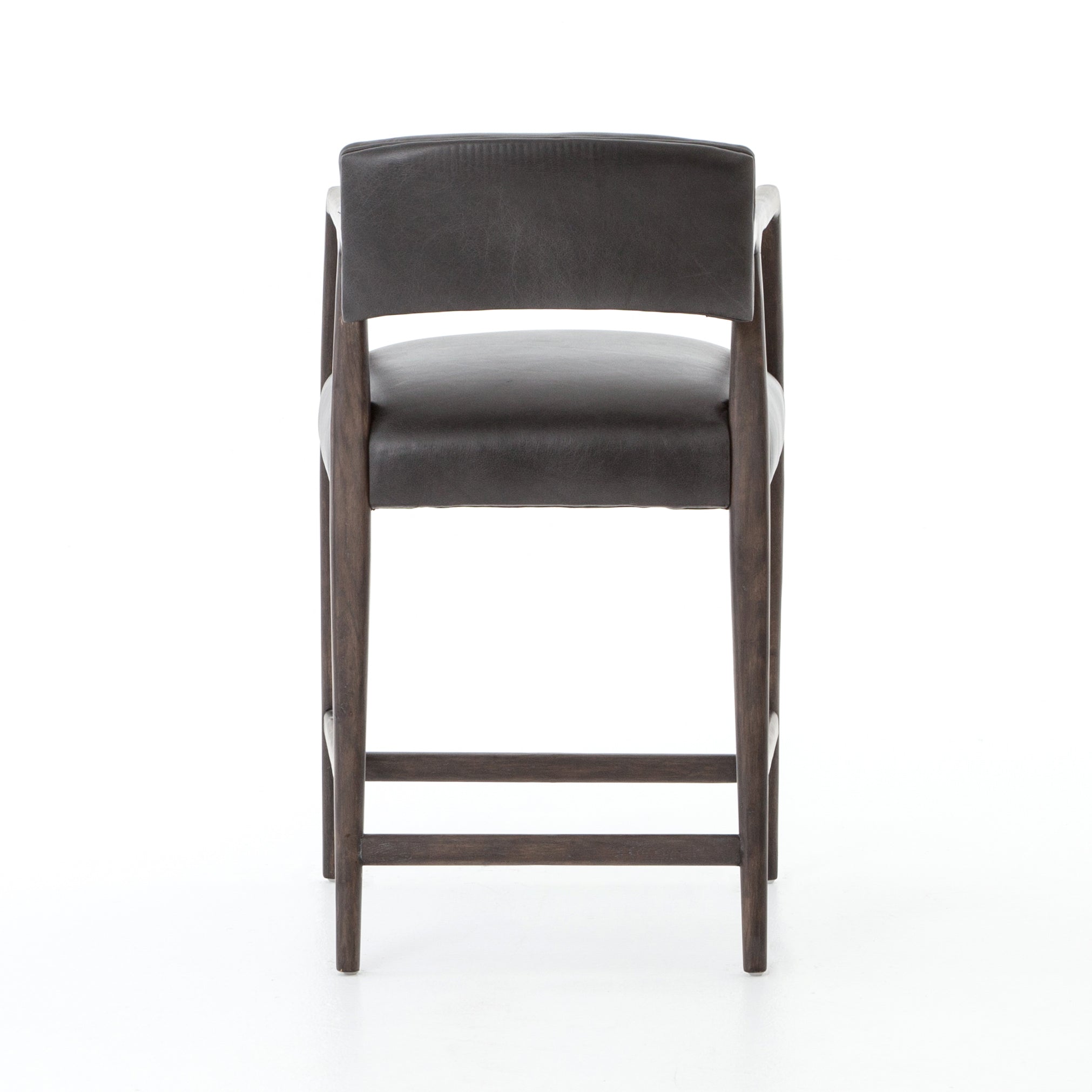 The Tyler Bar + Counter Stool - Ebony makes counter seating stylish with an angular, dark and smoky birch frame, a deep seat, and a striking, low-slung back. The stool is comfortable for long dinners and conversations with a covered black, top-grain leather seat and back.