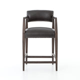 Featuring Tyler Chaps Ebony Counter Stool by Four Hands at Amethyst Home. The Tyler Counter Stool in Chaps Ebony makes counter seating stylish with an angular, dark and smoky birch frame, a deep seat, and a striking, low-slung back. The stool is comfortable for long dinners and conversations with a covered black, top-grain leather seat and back.
Counter StoolS.  Amethyst Home provides interior design, new home construction design consulting, vintage area rugs, and lighting in the Tampa metro area.