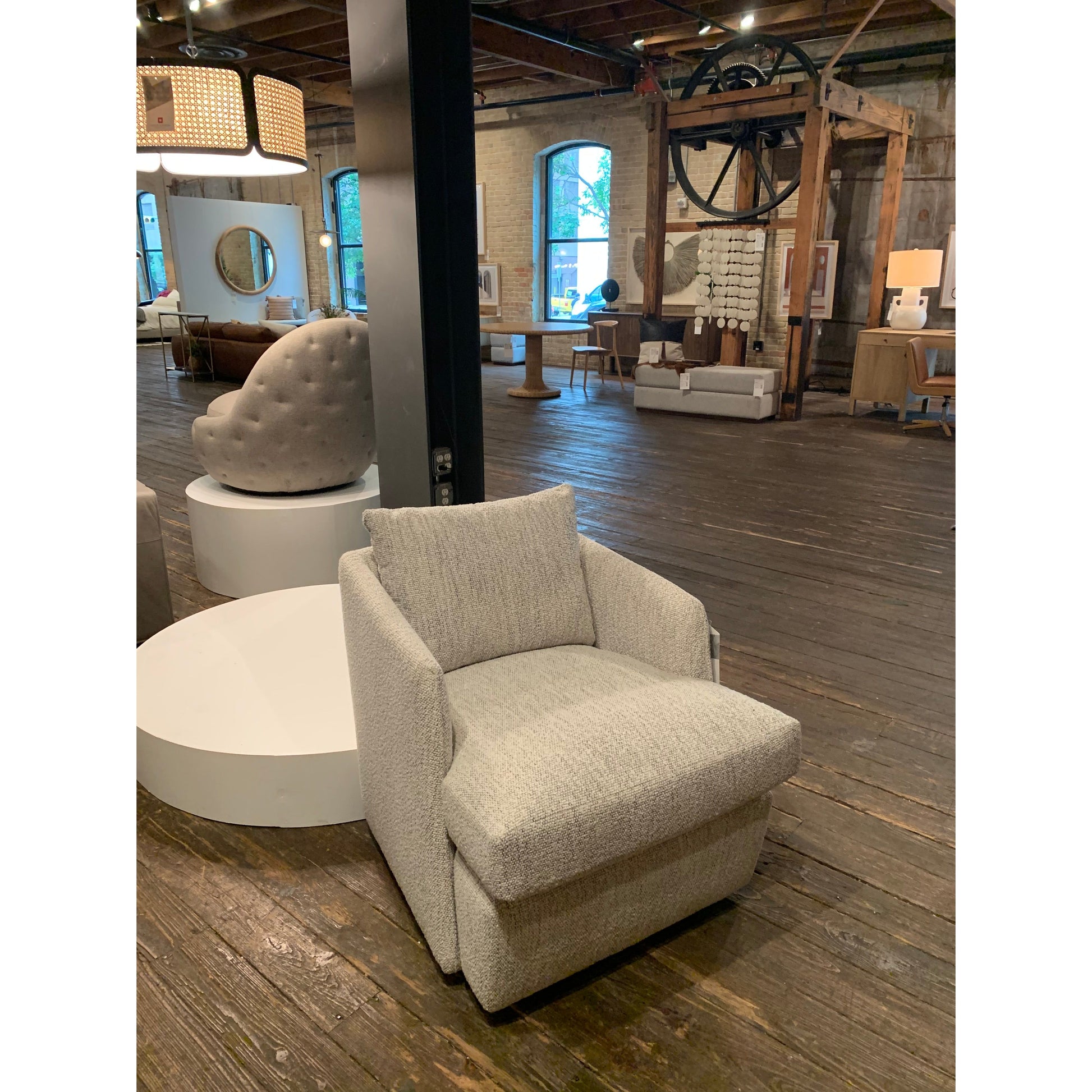 This Whittaker Swivel Chair - Merino Cotton is a comfortable classic. Atop a 360-degree swivel base, well-tailored cotton seating provides a beautifully simple place to perch in style, with feather-blend cushioning for total relaxation -- the perfect chair for a baby room, living room, or other area.   Overall Dimensions: 28.75"w x 35.00"d x 35.50"h